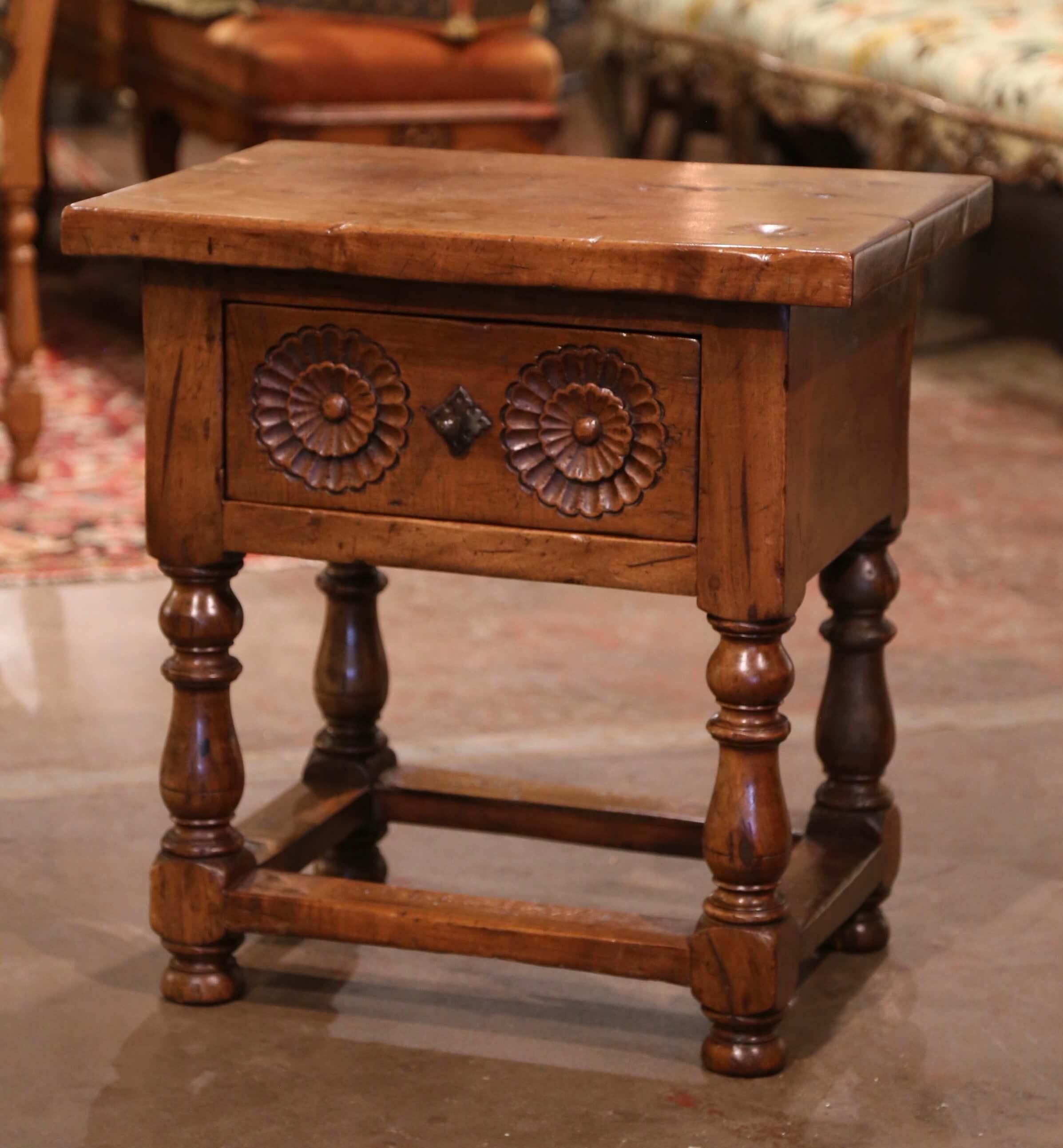 Incorporate extra, functional surface space into your living room or den with this elegant antique side table. Crafted in northern Spain circa 1880 and built of walnut, the side table stands on turned legs ending with bun feet, and embellished with