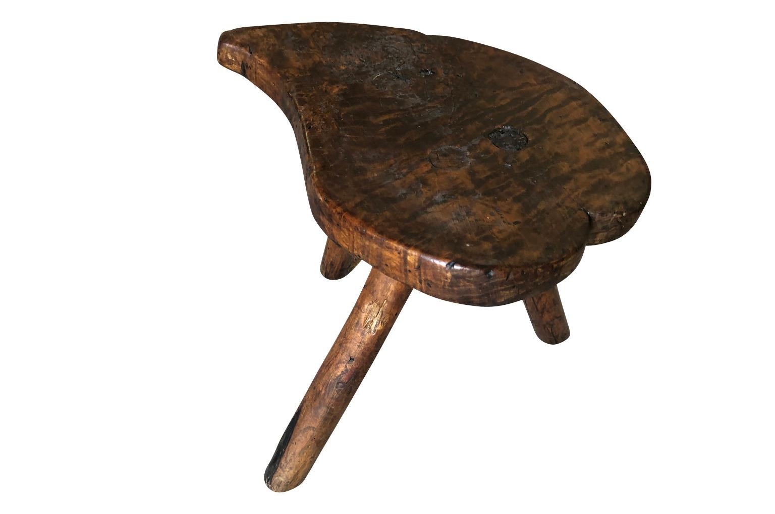 A delightful and primitive 19th century milking stool from the Catalan region of Spain. Wonderful patina and graining. A charming accent piece for any casual interior.