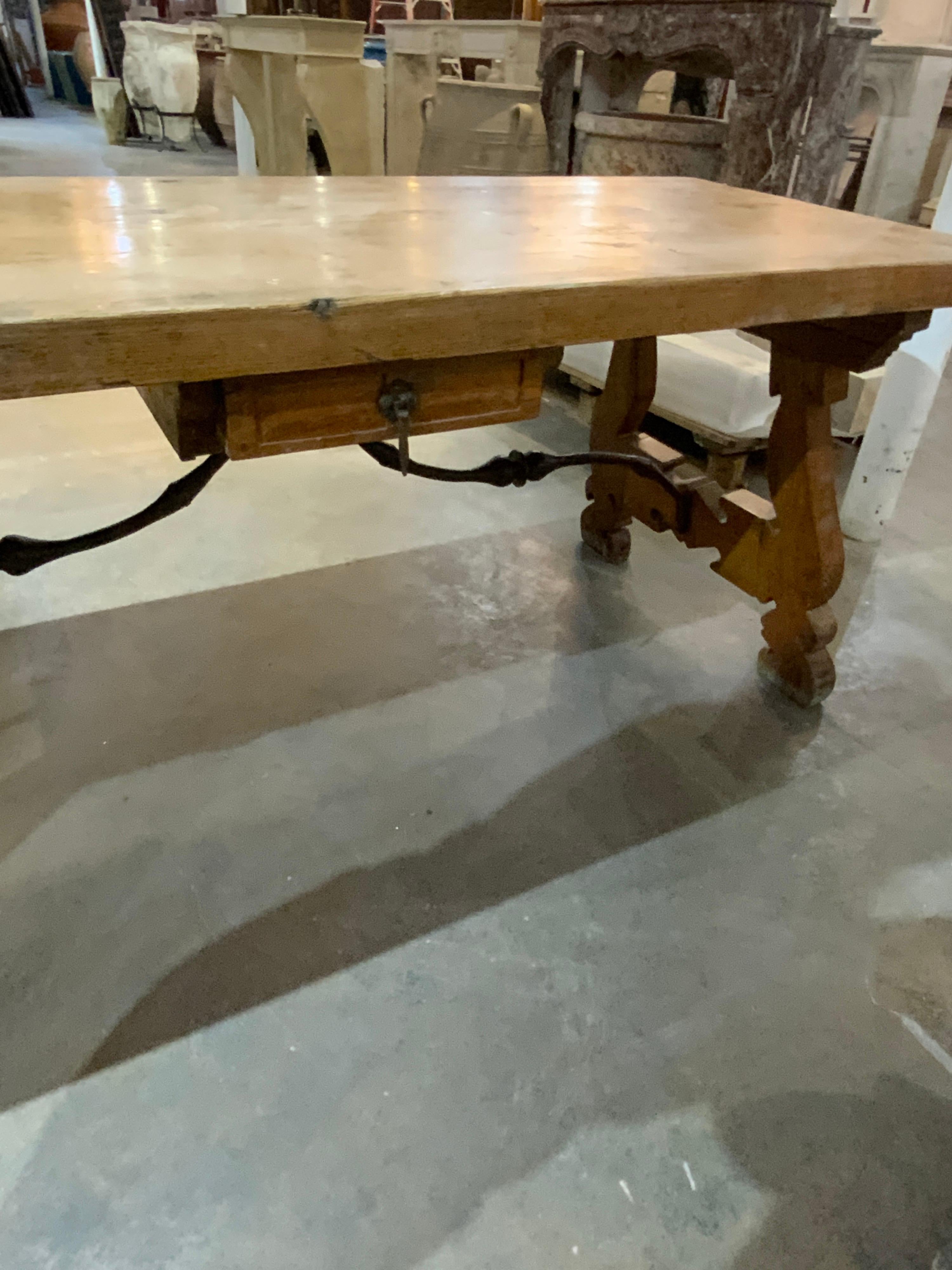 Gorgeous hand-carved table made of oak. Imported from Spain. This table features one drawer in the center and can be used as a desk.