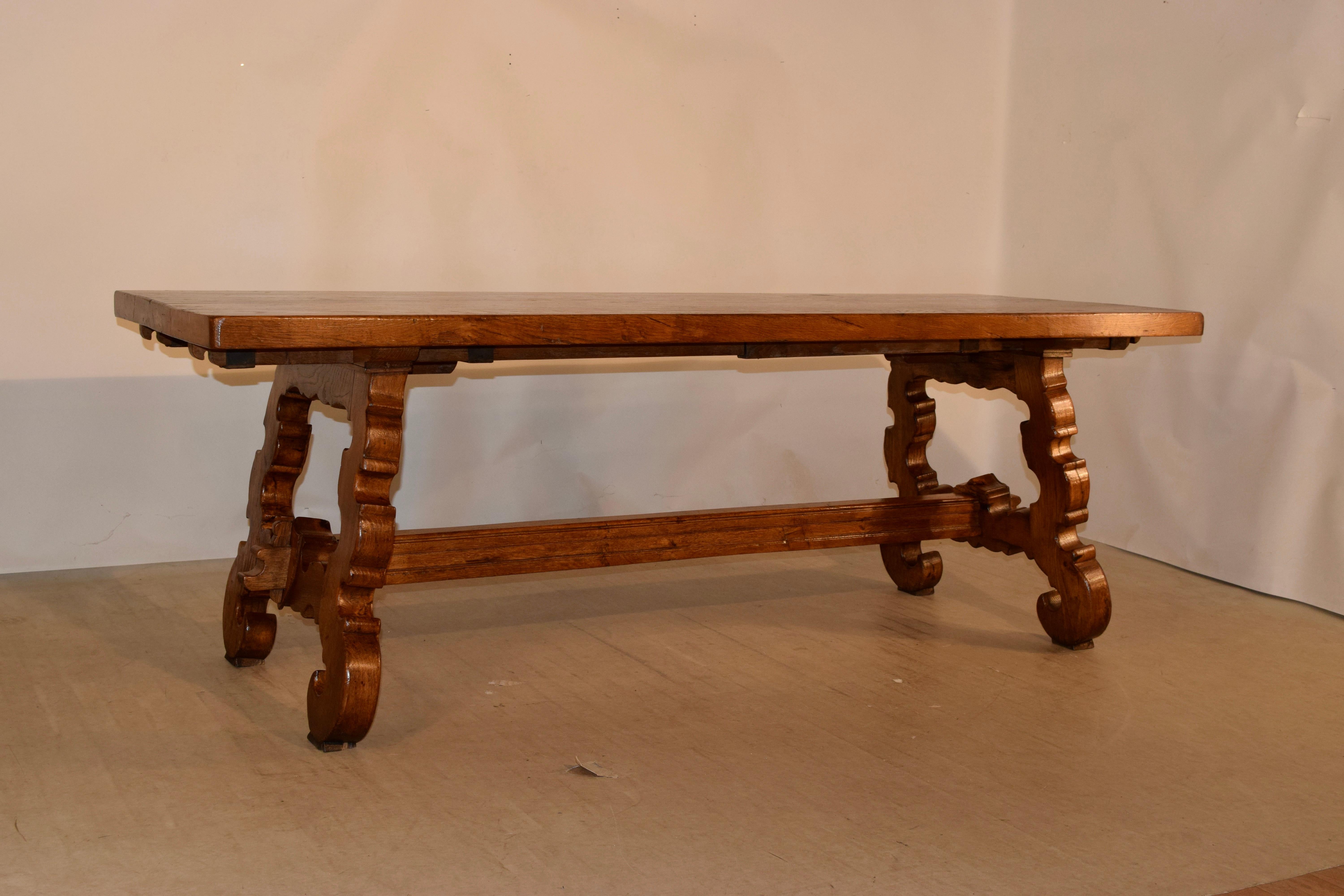 19th century Spanish oak table with a thick plank top which is 2.13 inches supported on splayed legs, which are wonderfully shaped and scalloped and joined by a shaped stretcher.
