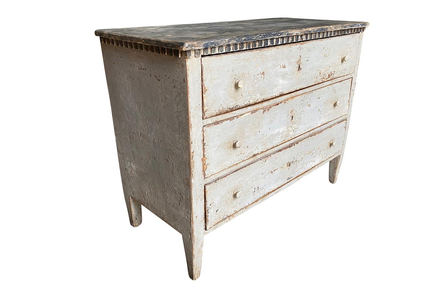 A wonderful later 19th century commode from the Catalan region of Spain. Soundly constructed from painted wood with dentilated detailing, three drawers over tapered legs. Terrific as a bedside table or converted into a vanity. Super patina.