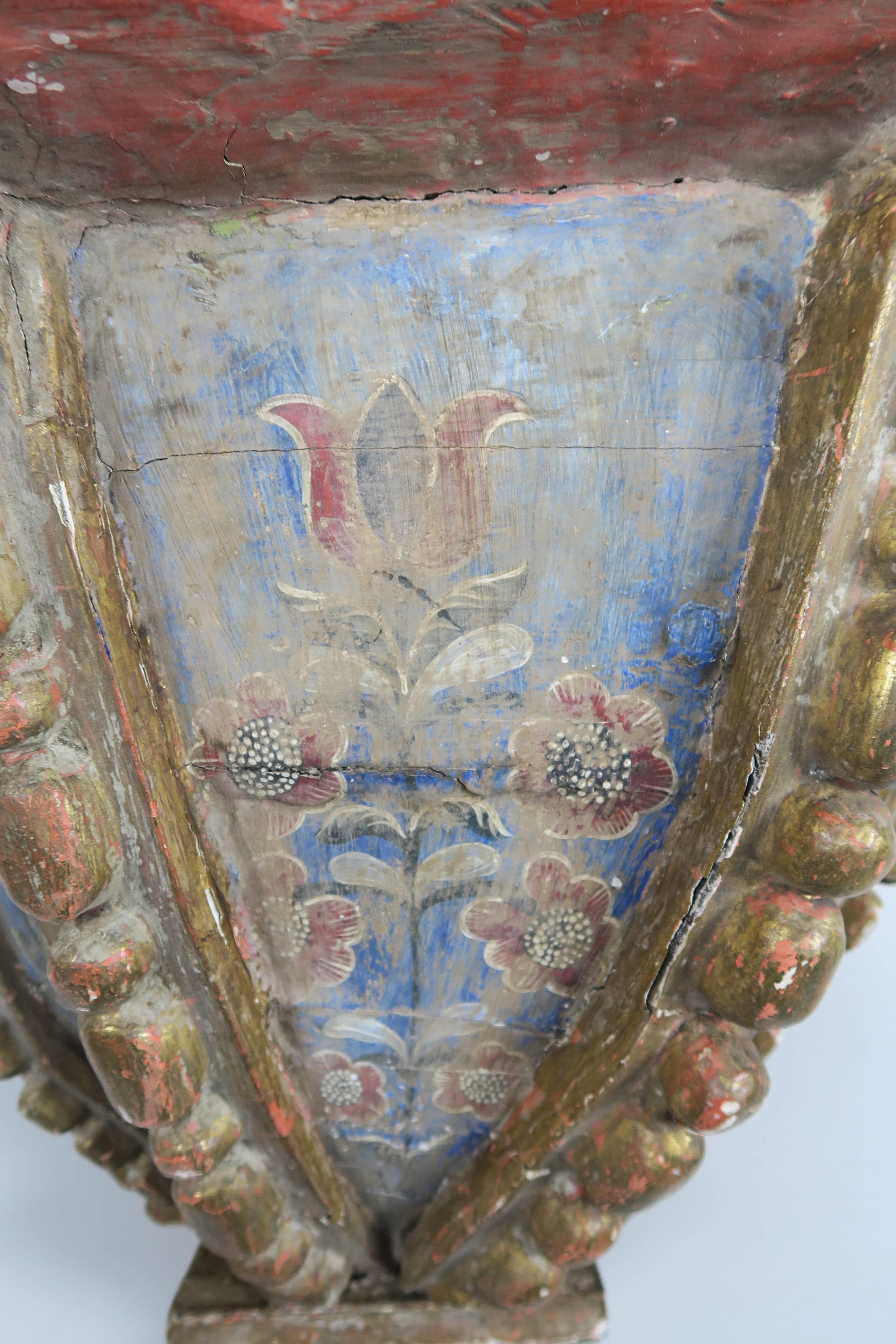 Early 19th century painted and parcel gold gilt Spanish Colonial style corbel with beautiful paintings of flowers throughout in beautiful shades of blues, rust and gold.