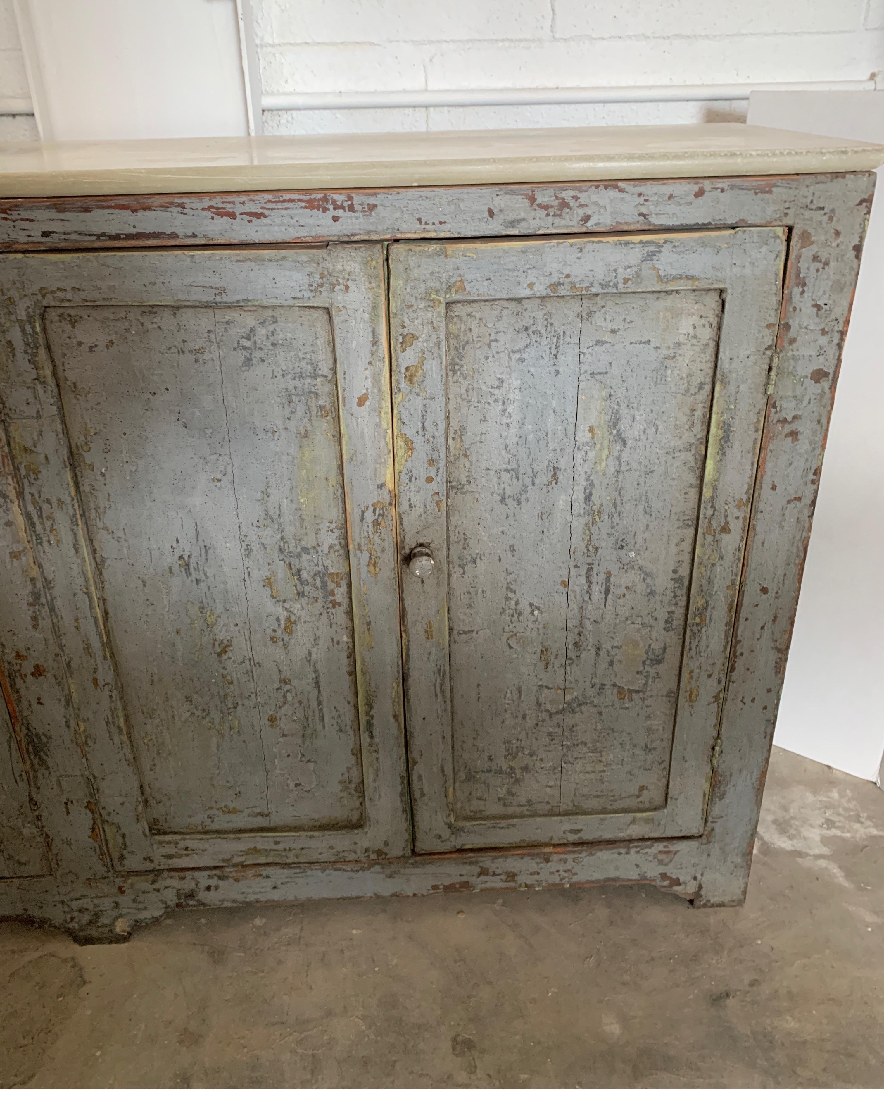 This is a great Spanish buffet that is narrow and not too long. It has a gray paint that is later and wooden pulls.
The back is painted the original blue.