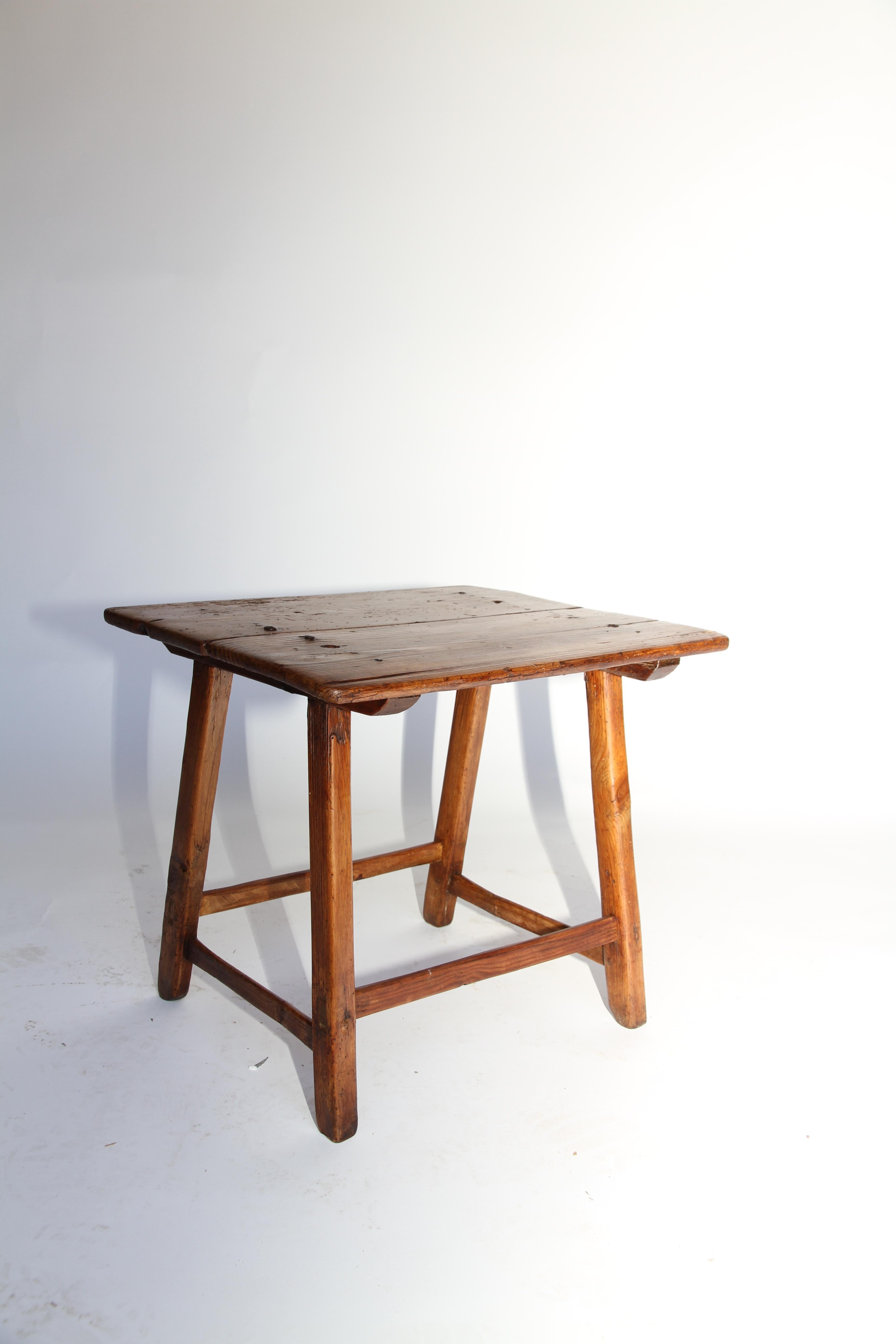 A rustic handcrafted Spanish low table with hand-forged iron nail detail on the top. This sturdy 19th century table is perfect as an end table, coffee table or drinks table. The rustic patina adds to it's charm.