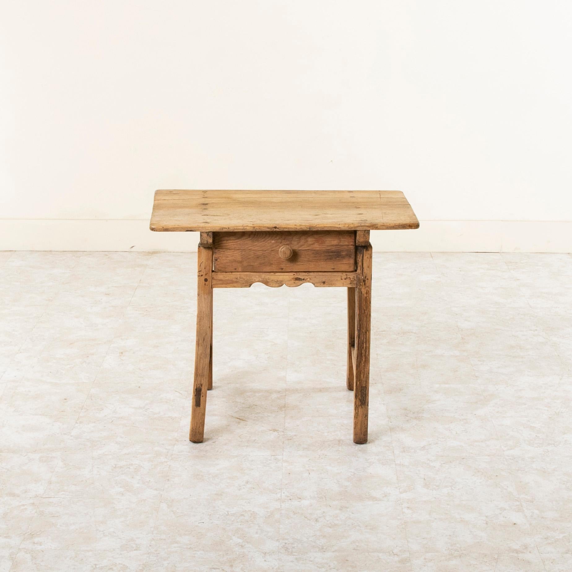 Created by a goat herder in the Pyrenees while tending his sheep, this late nineteenth century Spanish pitch pine mountain table is constructed of hand pegged mortise and tenon joinery. The top is is formed by two planks of wood and is hand pegged