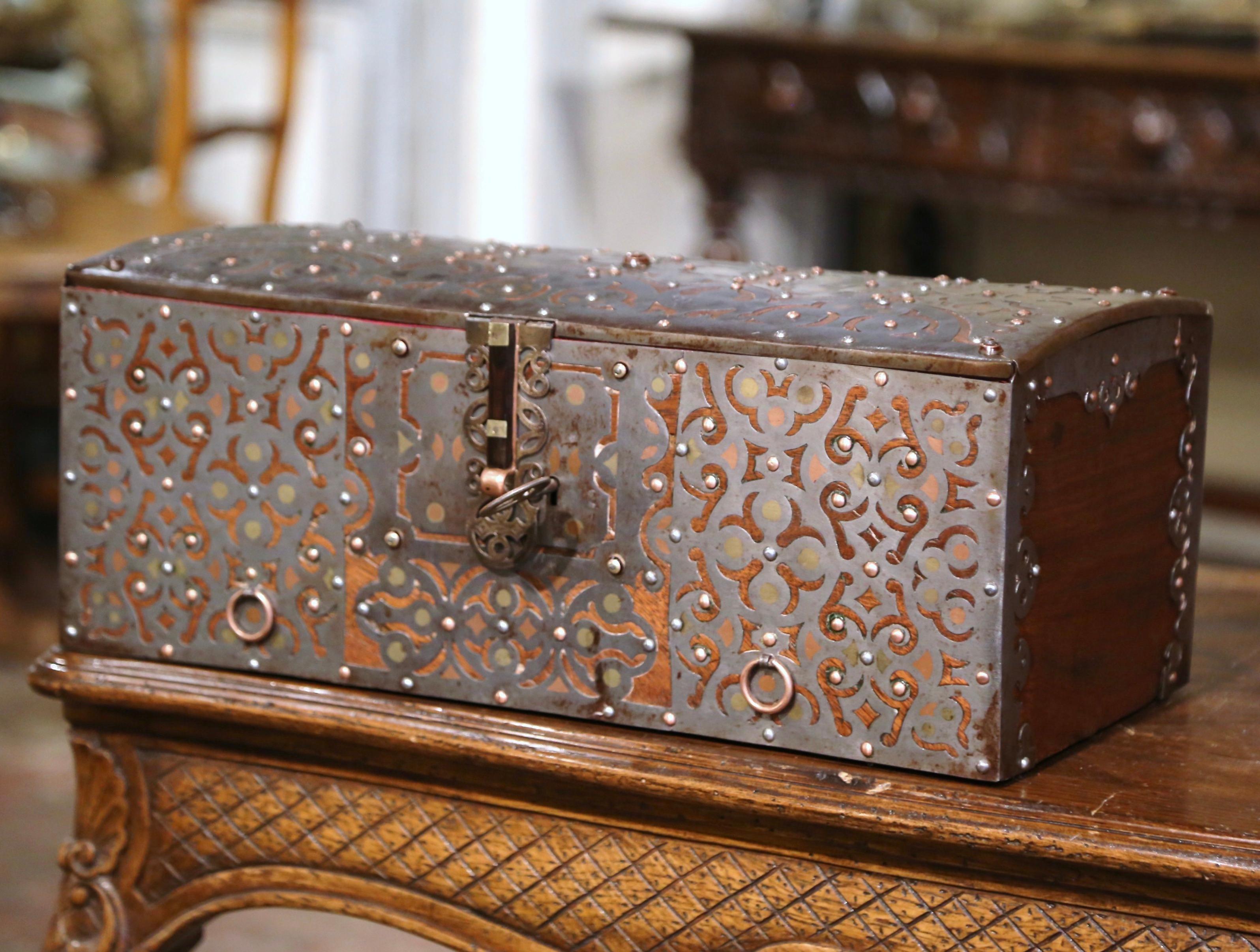 Decorate a shelf or a counter with this elegant antique decorative trunk. Crafted in Spain circa 1880, the strong box is decorated with pierced and engraved geometric motifs throughout. The Gothic style casket is in excellent condition commensurate