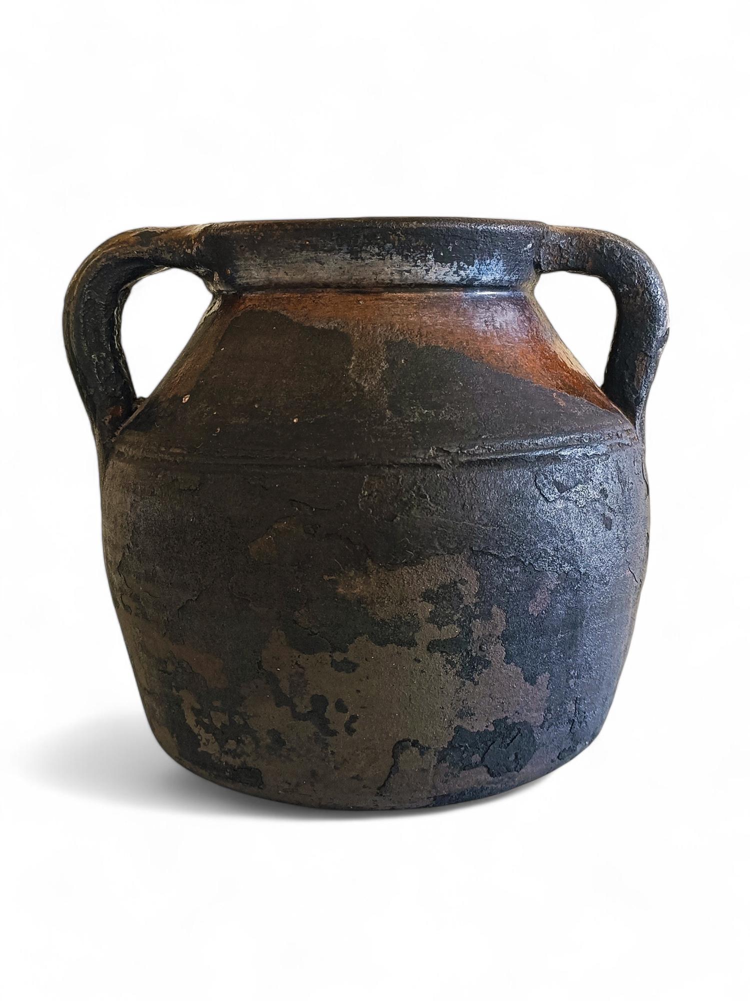 An antique Spanish cooking terracotta jar from the 19th Century with a weathered patina. 

This kind of pottery was used in Europe during centuries to cook on the fireplace, placing them on top of an iron tripod, thus its rounded base. 

The black