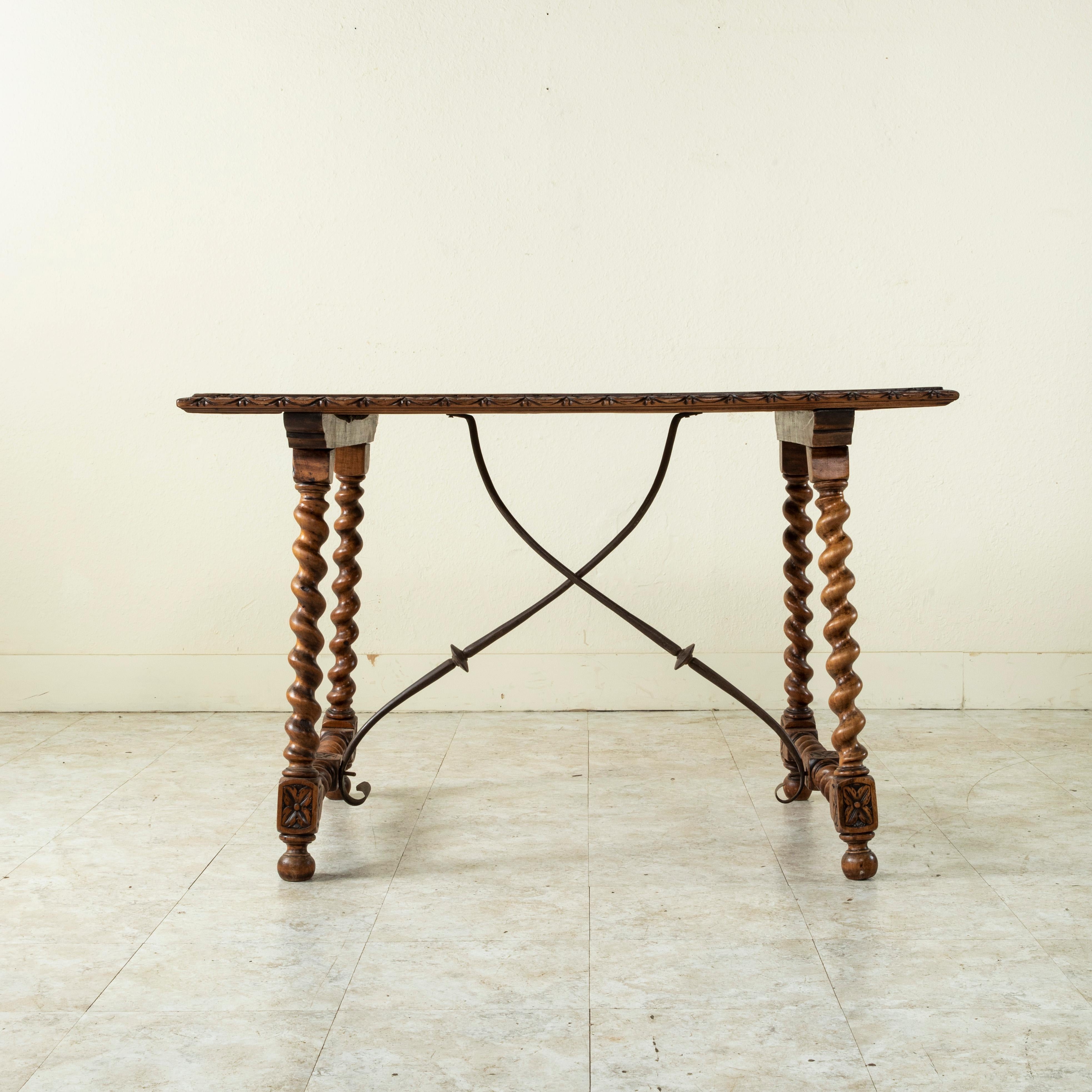 French 19th Century Spanish Renaissance Style Walnut Table with Forged Iron Stretcher