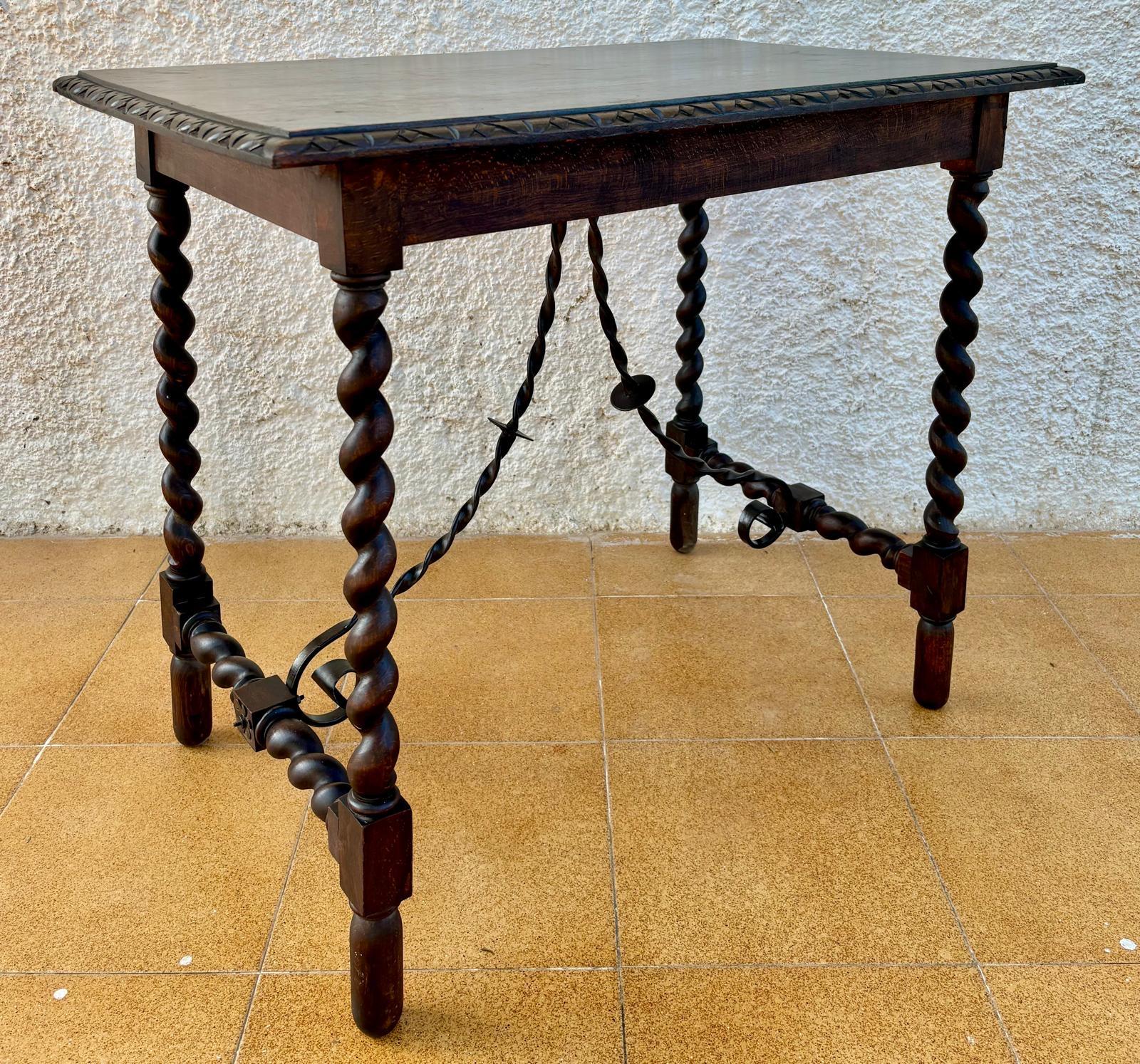 19th Spanish side table with cared Solomonic turned legs and iron stretcher. The top has a carved edges and a beautiful grain and patina.