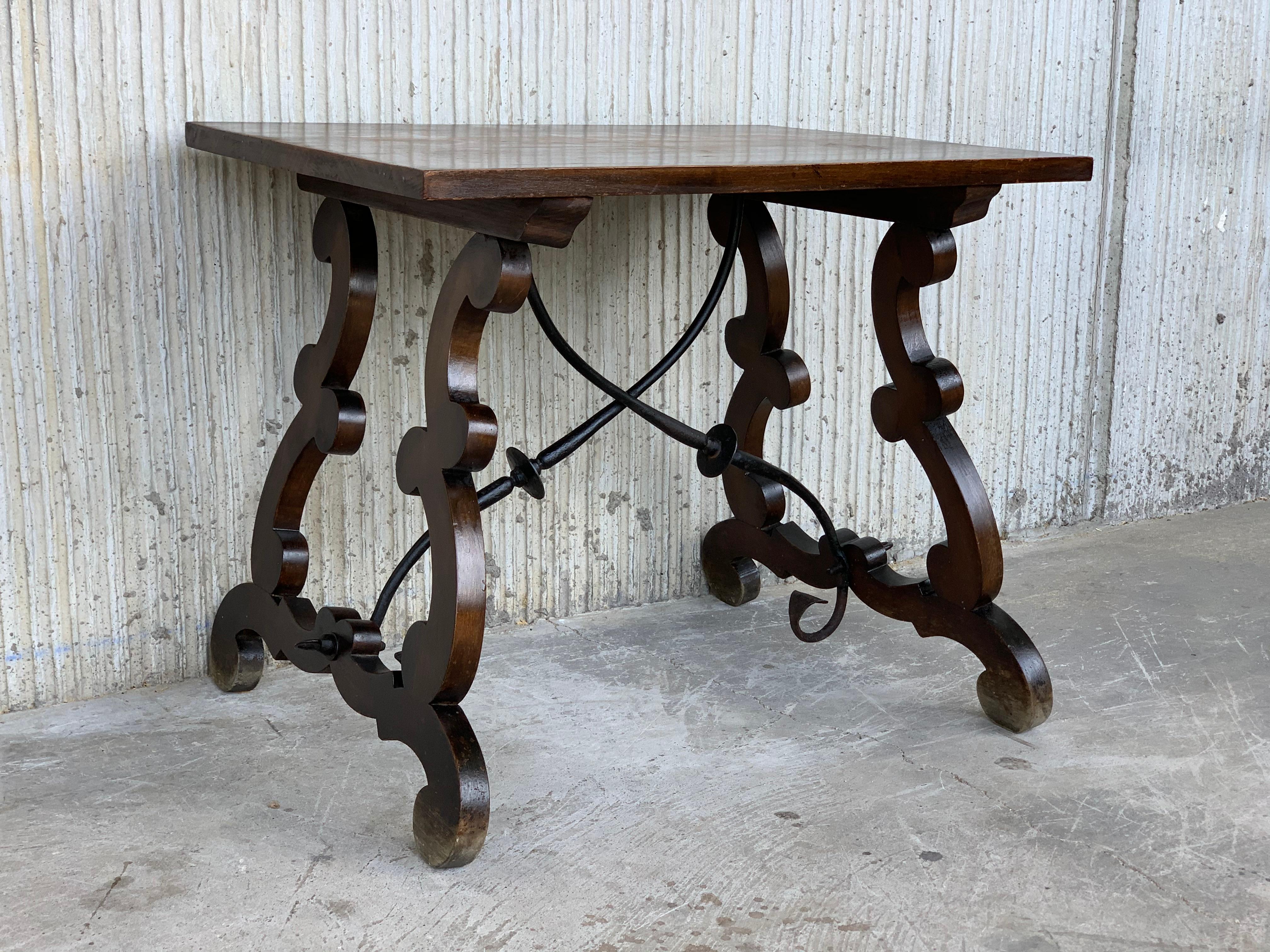 19th century Spanish side table with hand carved lyre leg and iron stretcher.