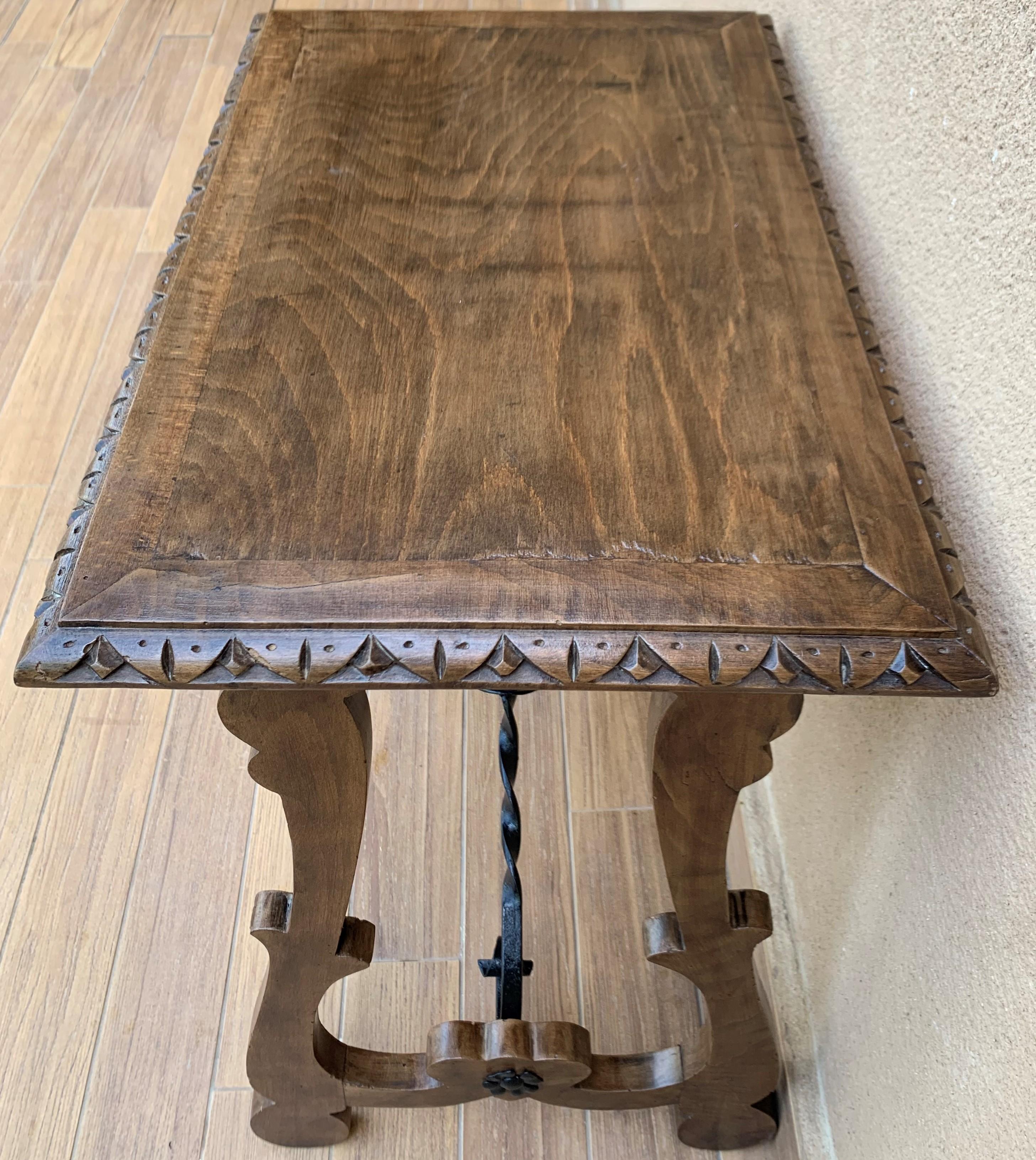 19th century Spanish side table with hand carved lyre leg and iron stretcher.
Exquisite antique hand carved lyre-leg walnut wood Fratino trestle table with iron stretchers in Baroque style, Spain, 1880s.
This gorgeous Fratino table features a