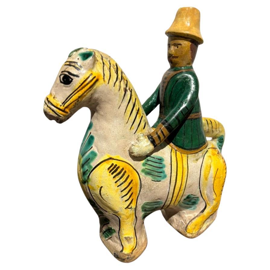 19th century Spanish Talavera glazed and hand painted drinking vessel, or bottle, in the form of a horse and rider. The top of the riders conical hat is open and the body is hollow to hold liquids This whimsical piece is a unique decorative item