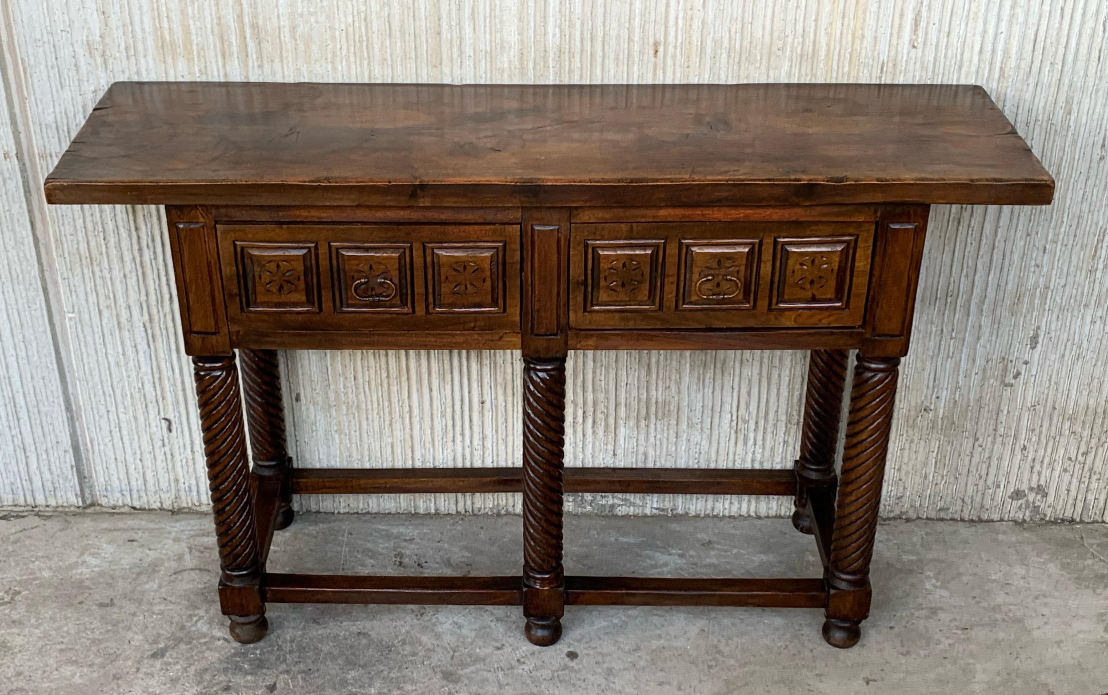 19th century Spanish console table with two hand carved drawers and Solomonic hand carved twist legs.
This piece is very heavy is because it has an additional leg in the middle.