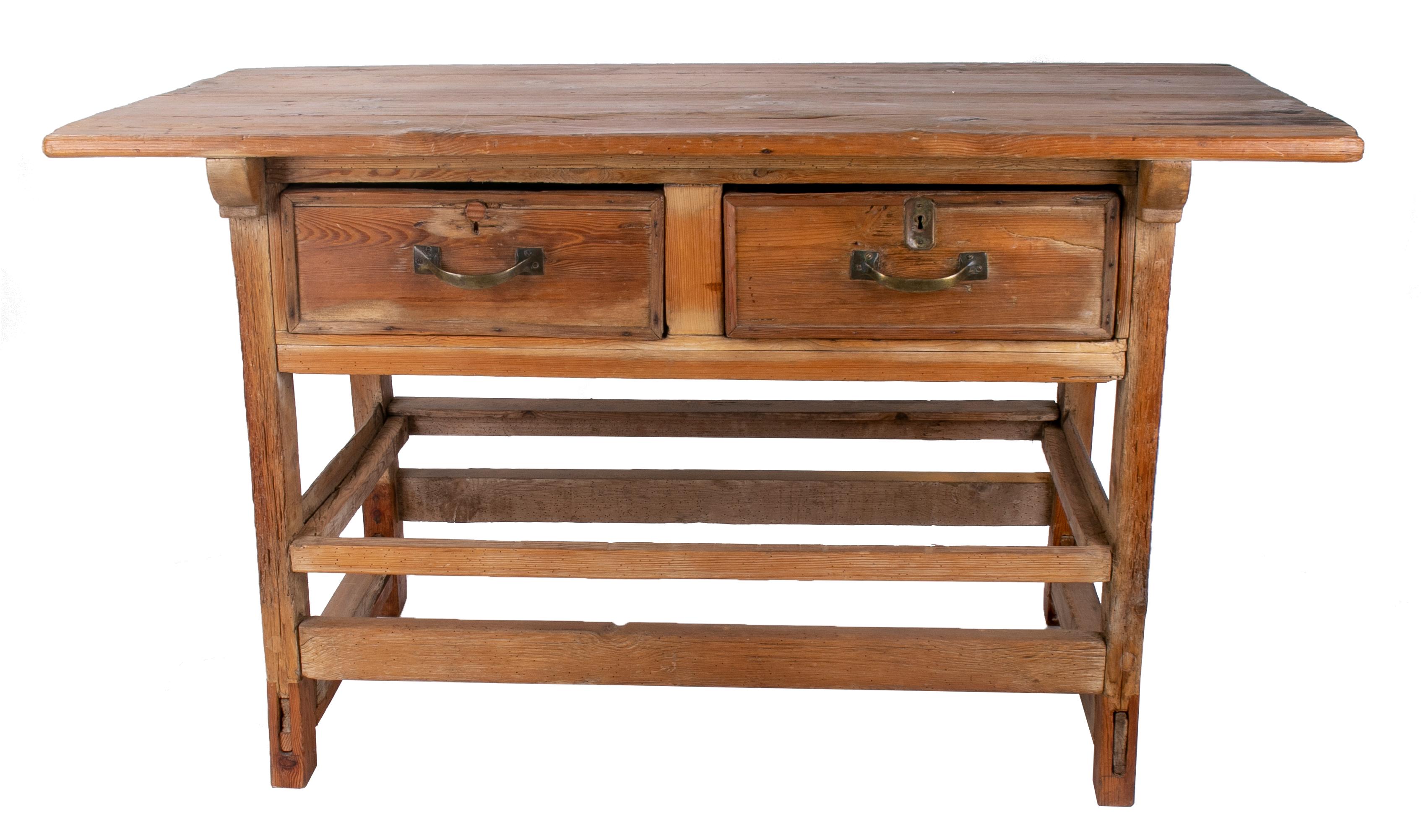 19th century Spanish two drawer rustic table with iron handles.