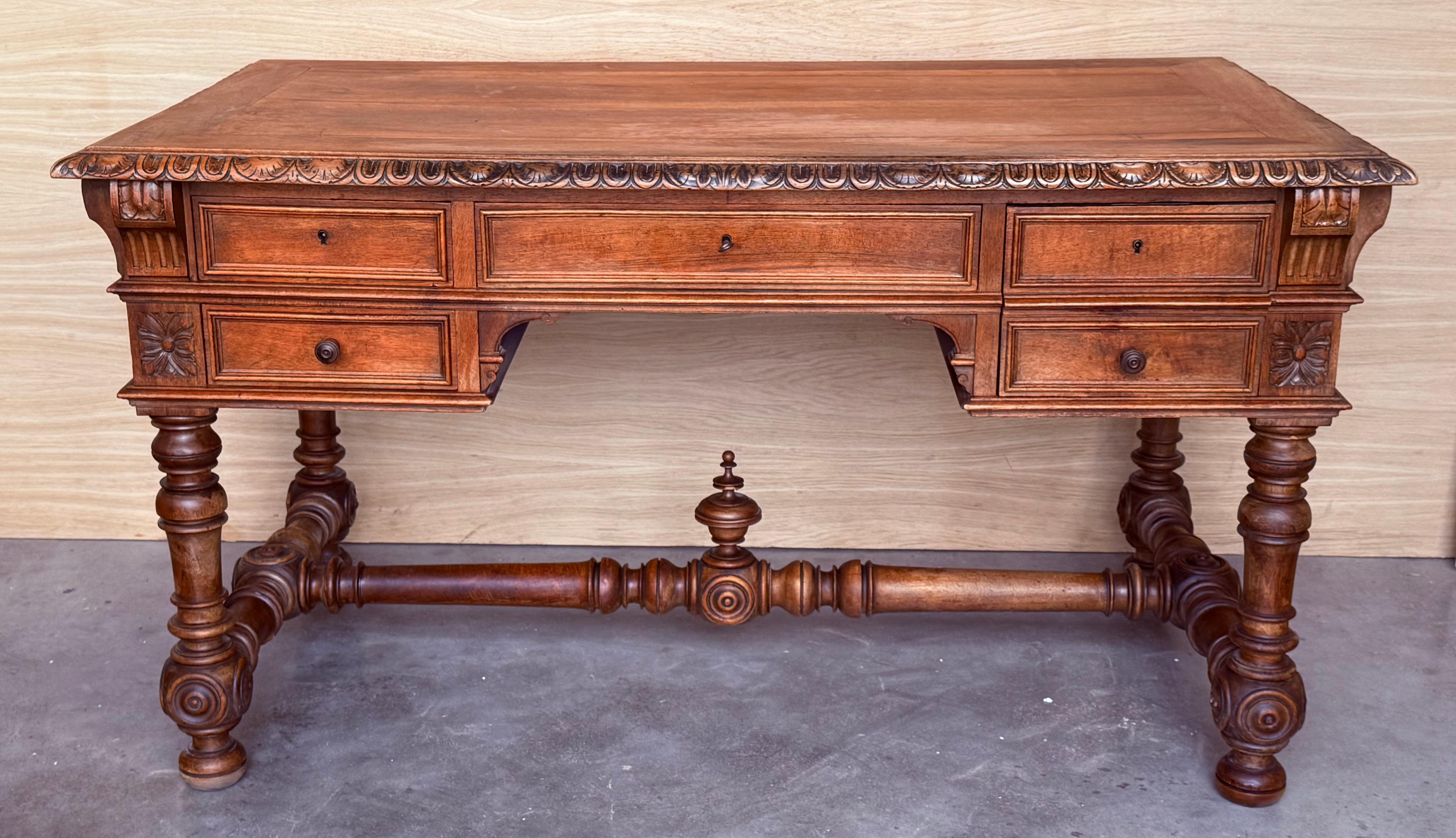 Handsome oak library piece that can be used as a desk or Work table. Made of oak having carved gadrooned edges. A stretcher made of iron. Carved on all sides and five drawers ox bow ends, 19th century.
Workable locks and keys.

Height from the floor