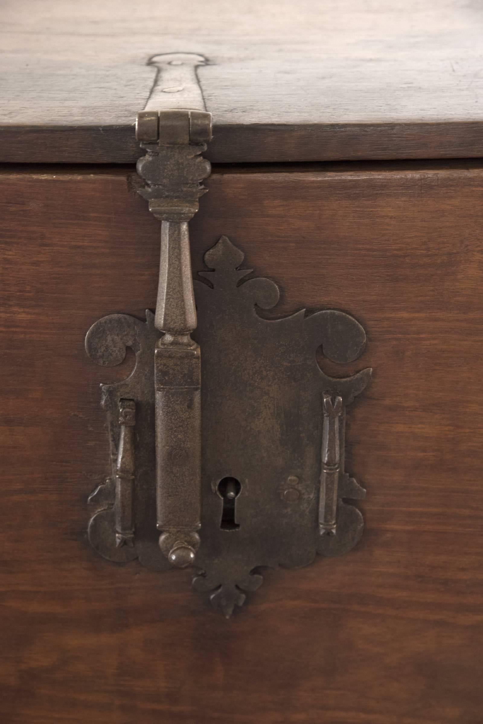 A two-piece, 19th century Spanish vargueno, or portable desk, made of walnut with mounted brass brackets, two tracery pulls and shaped escutcheon, with two brass handles on either end of box for transportation. The drop front opens to an interior