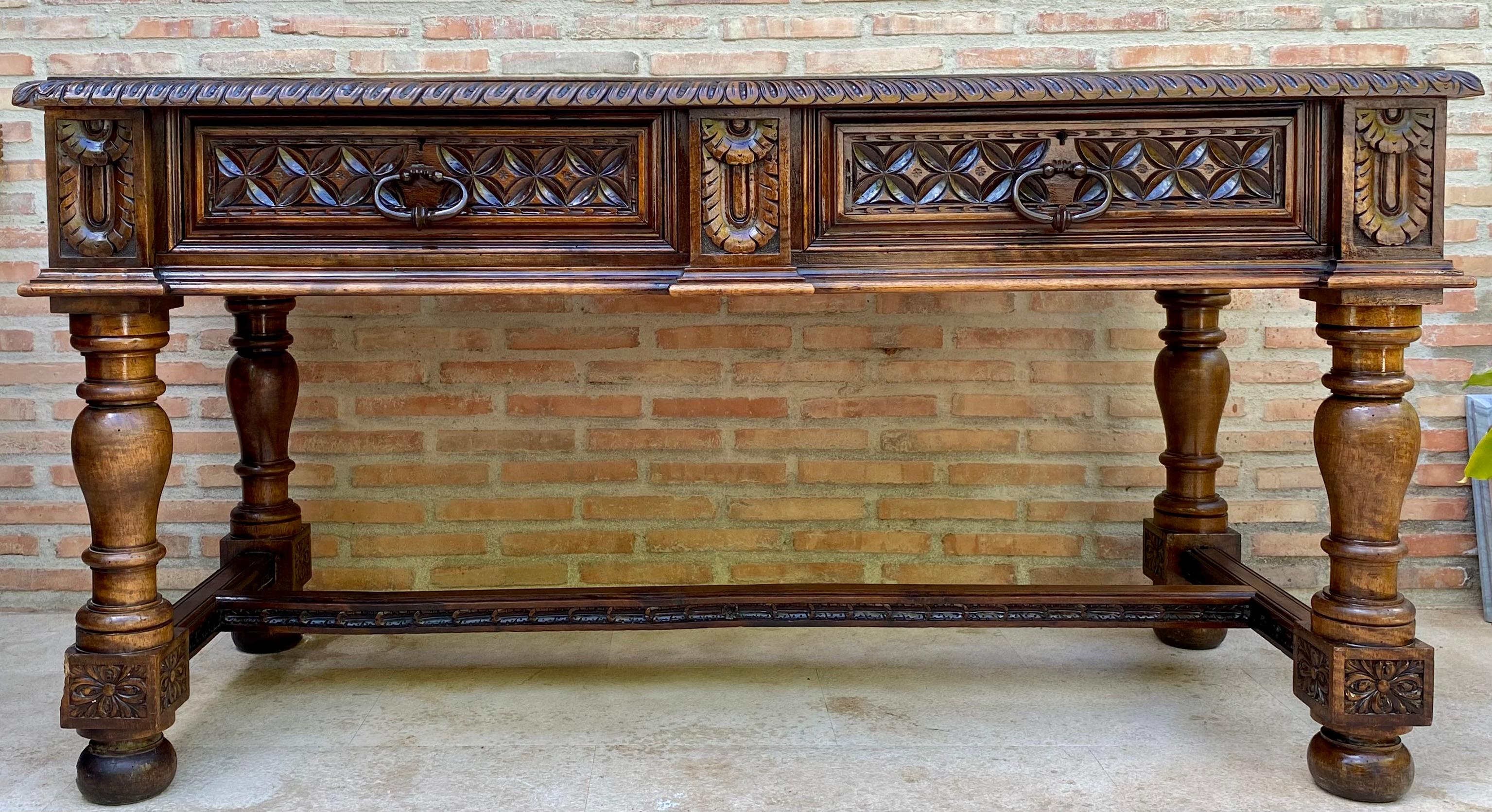 
19th Spanish walnut desk or console table with two drawers and strong turning legs and stretcher.