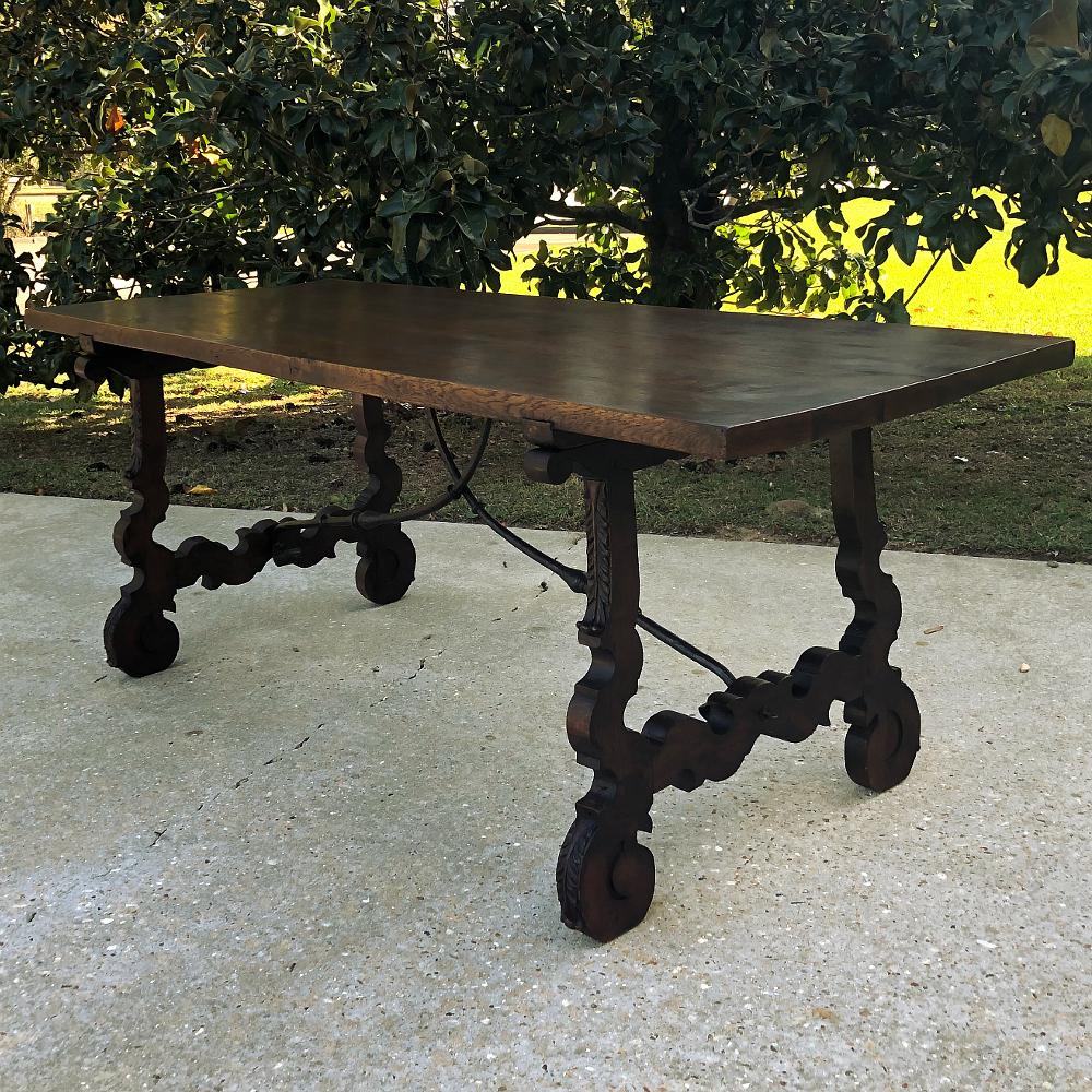 19th century Spanish walnut dining table represents the extraordinary craftsmanship handed down from father to son for centuries in the Iberian Peninsula! The unique look originating from that region of the world includes intricately band-sawn legs