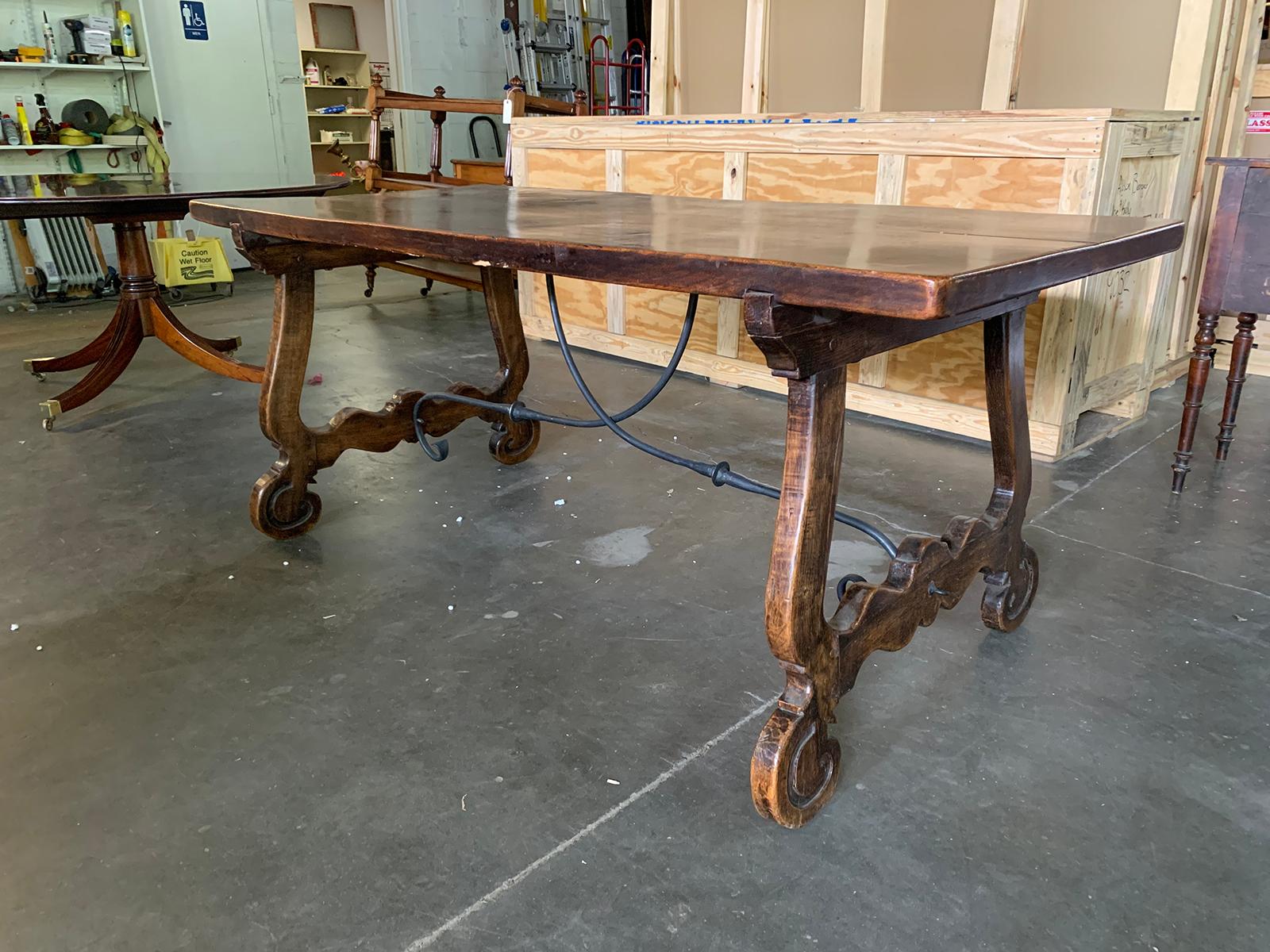 19th century Spanish walnut-top trestle table with iron stretcher, circa 1860.