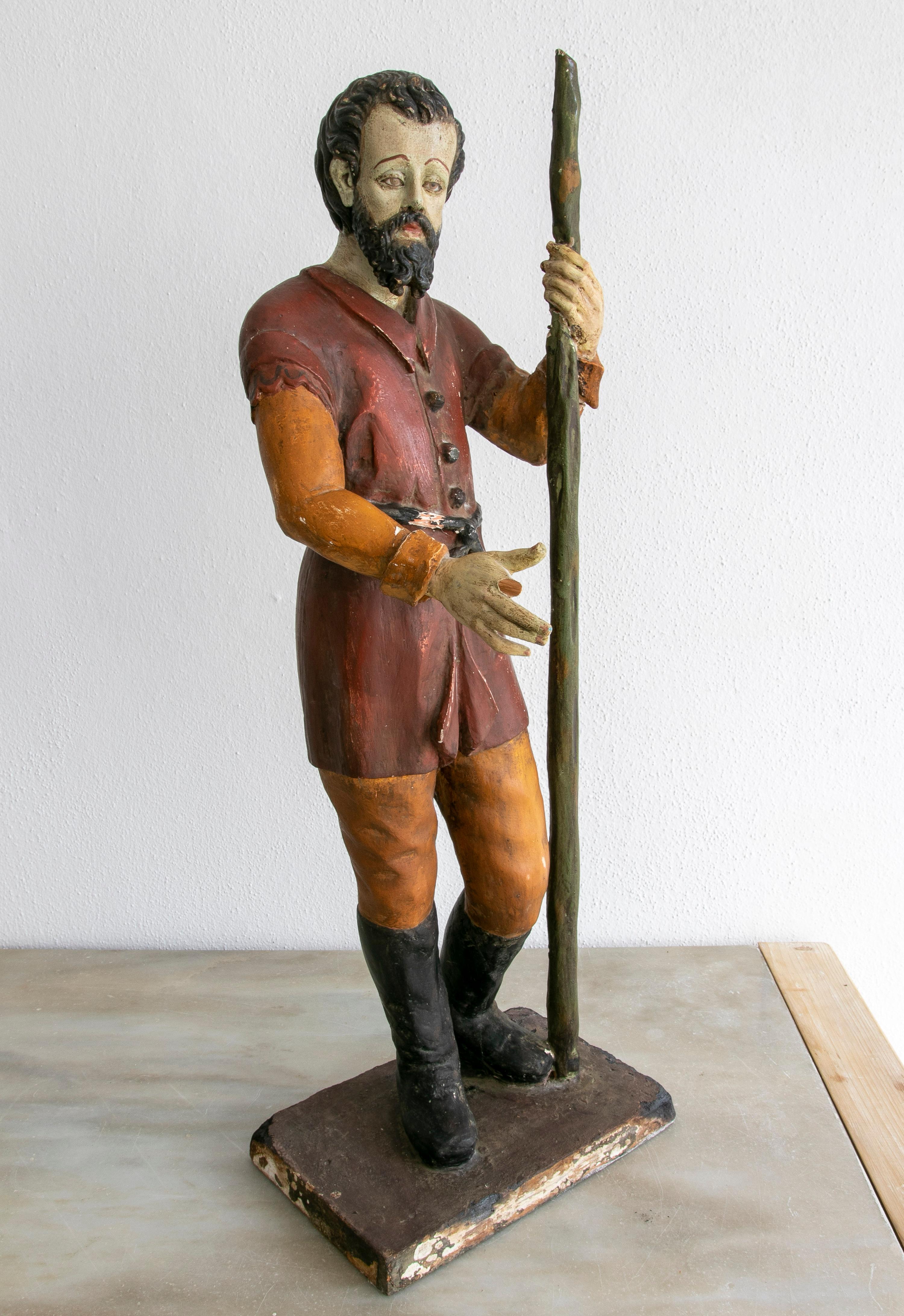 Mid 19th century Spanish wooden painted hand carved figure sculpture of a saint holding a long stick.

 