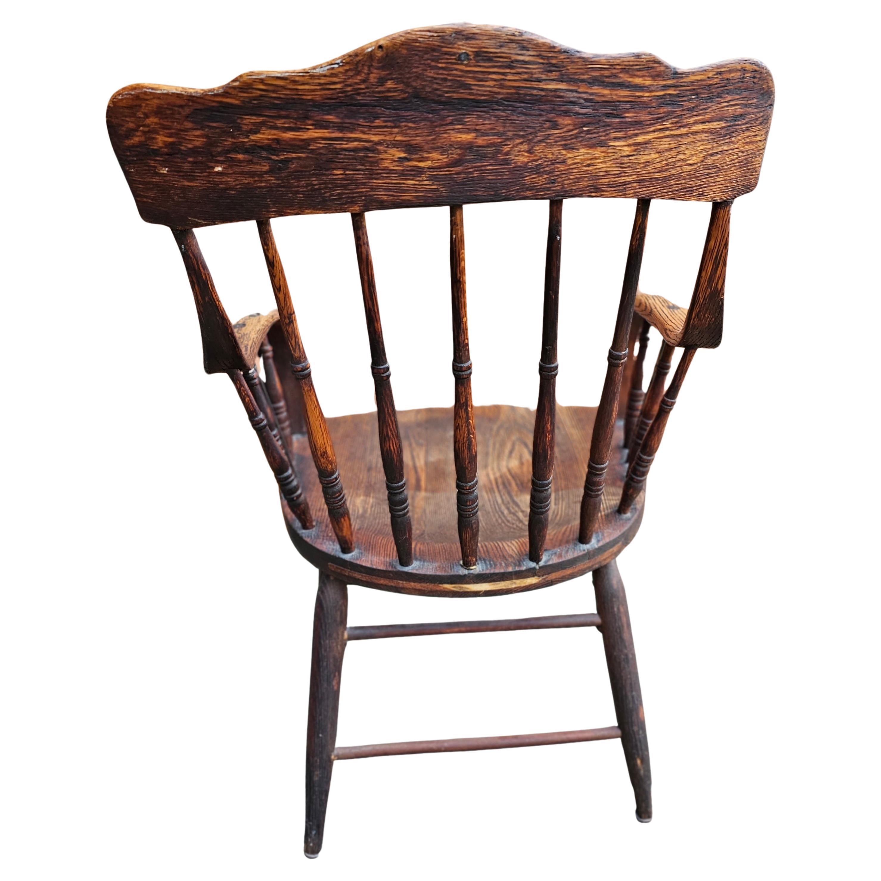 A 19th Century Spindle Oak Windsor Continuous Arm Chair in sturdy condition. Measures 22