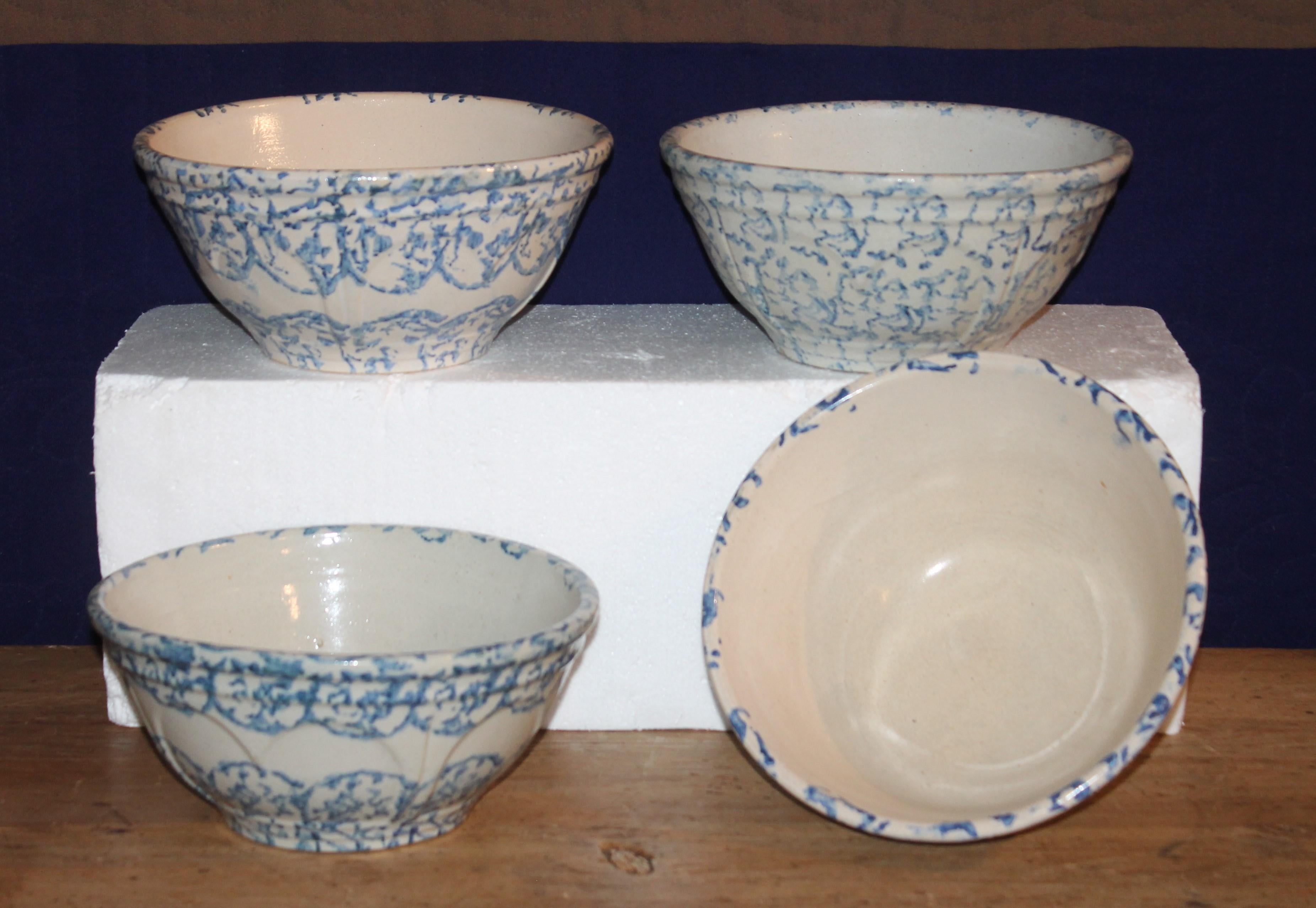 These fine handmade pottery sponge ware mixing bowls are in pristine condition. Sold as a collection of four bowls with clam shell pattern.