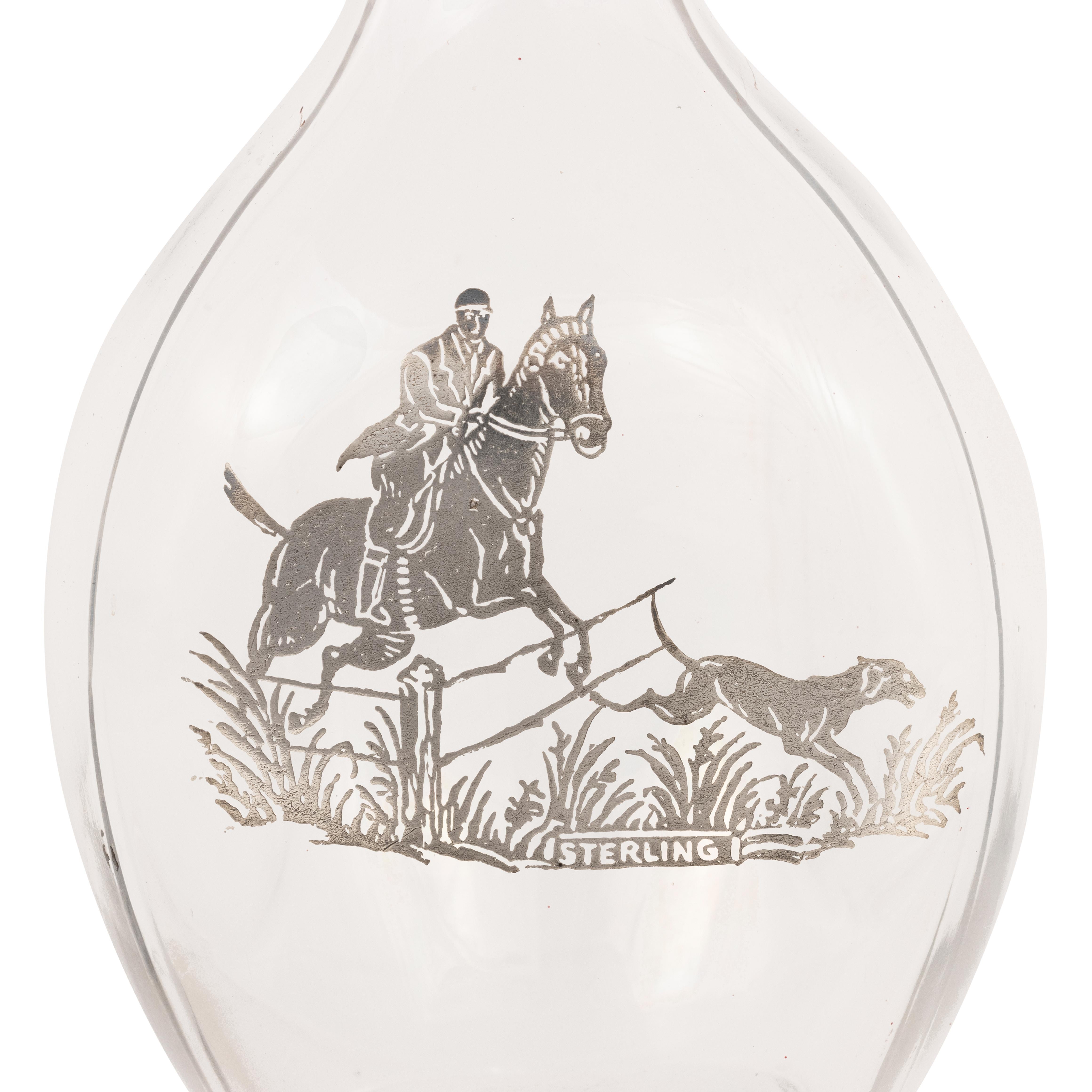 Sporting theme back bar bottle with sterling motif of fox hunter and hound. Original stopper. Pinch bottle three piece glass mold.

PERIOD: 19th Century

ORIGIN: California

SIZE: 5