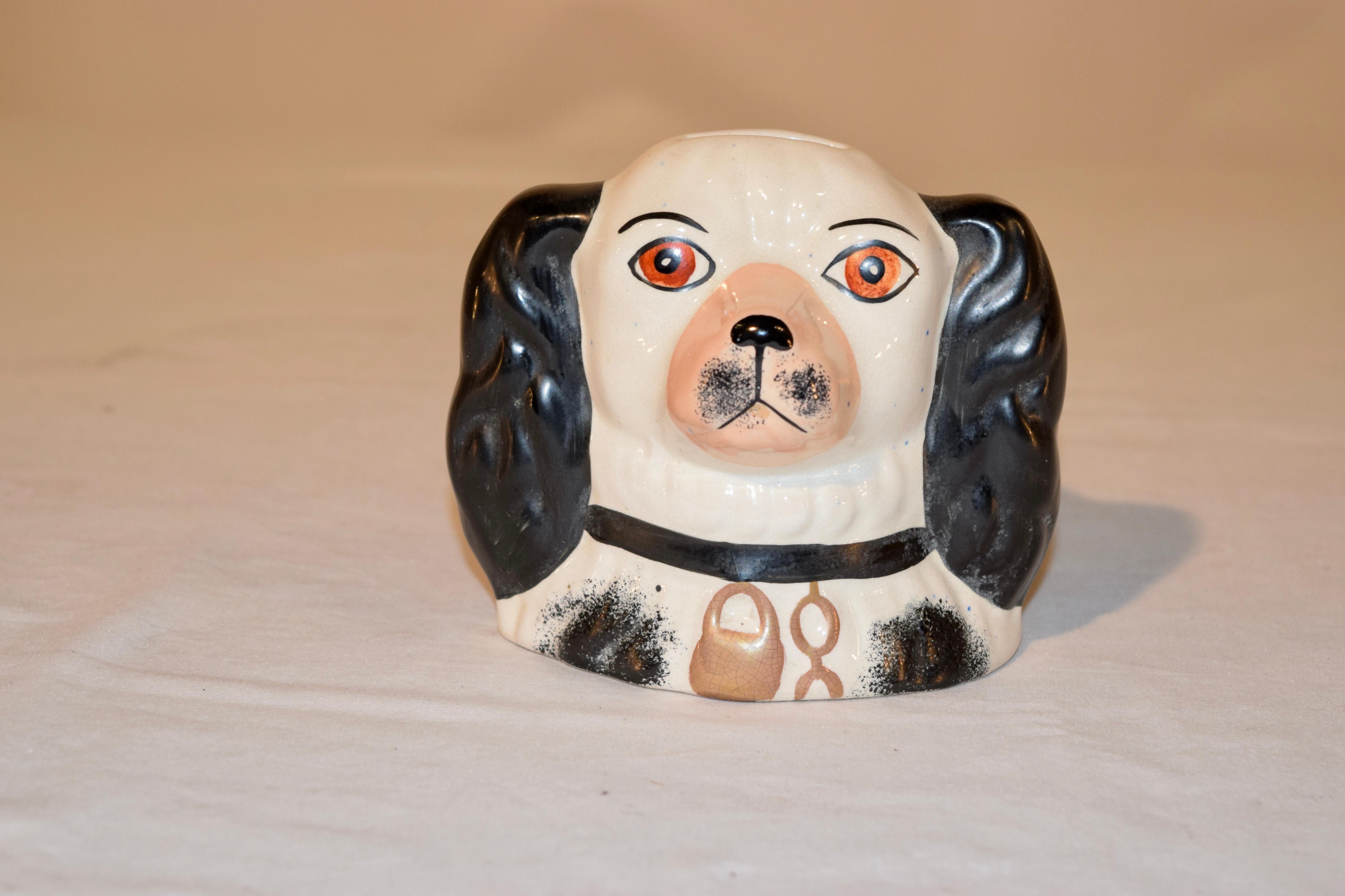19th century Staffordshire dog bank from England in black and white with hand painted decoration.