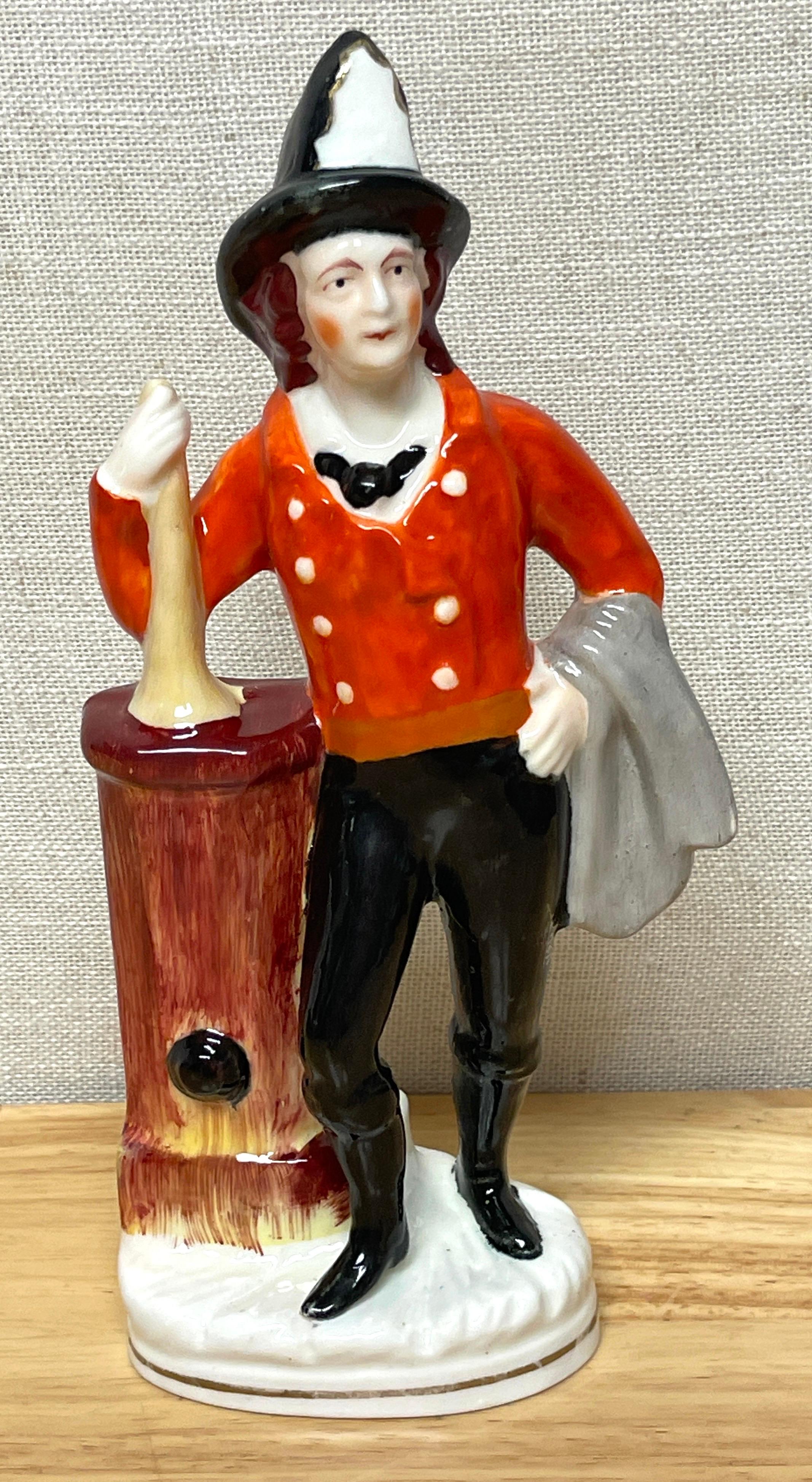 19th century Staffordshire figure of 'American Fireman'
England, Circa 1860s
A rare example, well painted and modeled of a fireman in uniform leaning against a water pump holding a horn in the left arm. The right arm is draped with a cloth. 
The