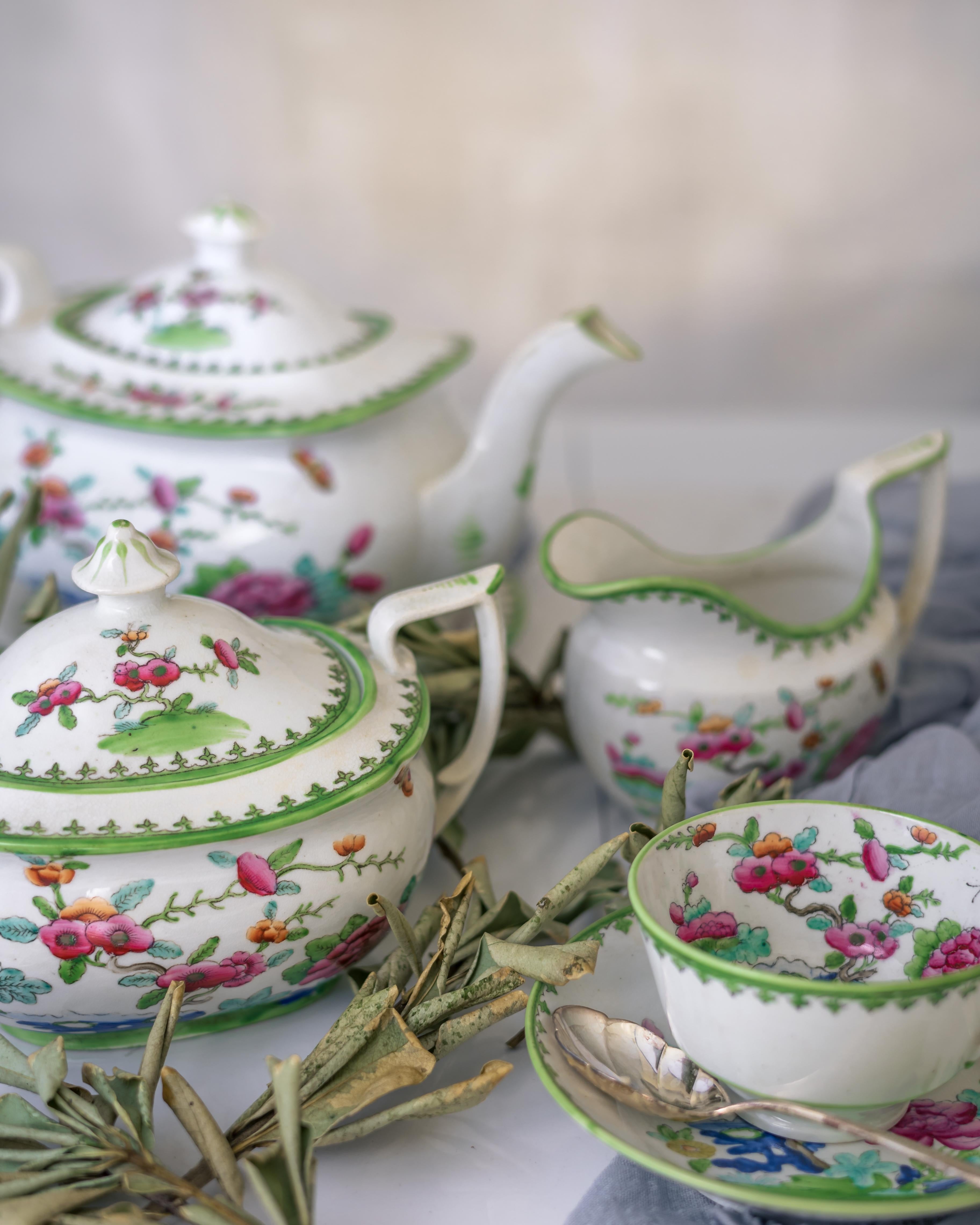 A Staffordshire porcelain tea set, made ca. 1840 in the chinoiserie style with beautiful pink and orange floral decoration accented with apple green details.

Staffordshire was the esteemed heart of England's ceramic production since the early