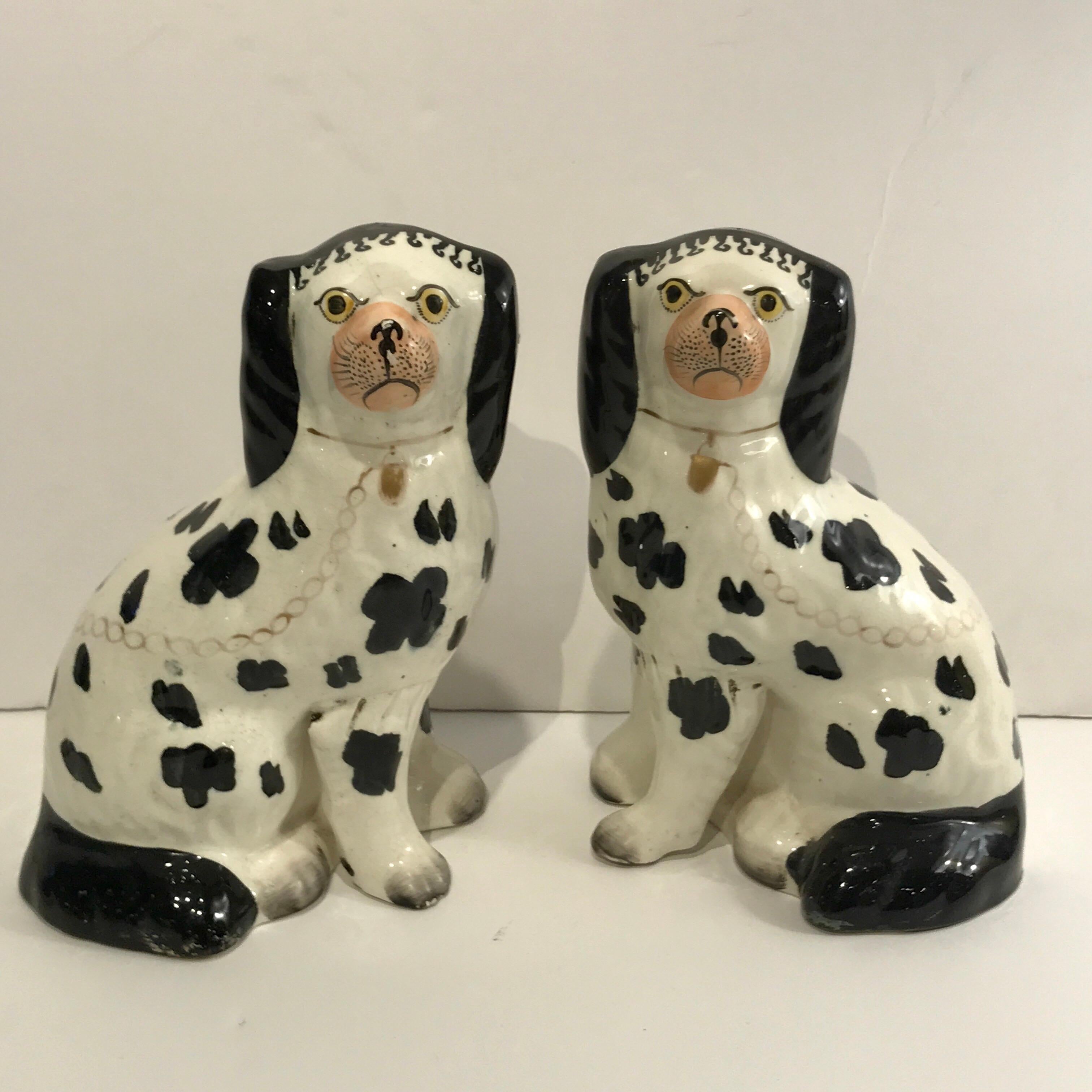 19th century Staffordshire seated Disraeli black and white spaniel dogs with the separate front legs, wonderful decoration, and all over painted black spots.















  
 