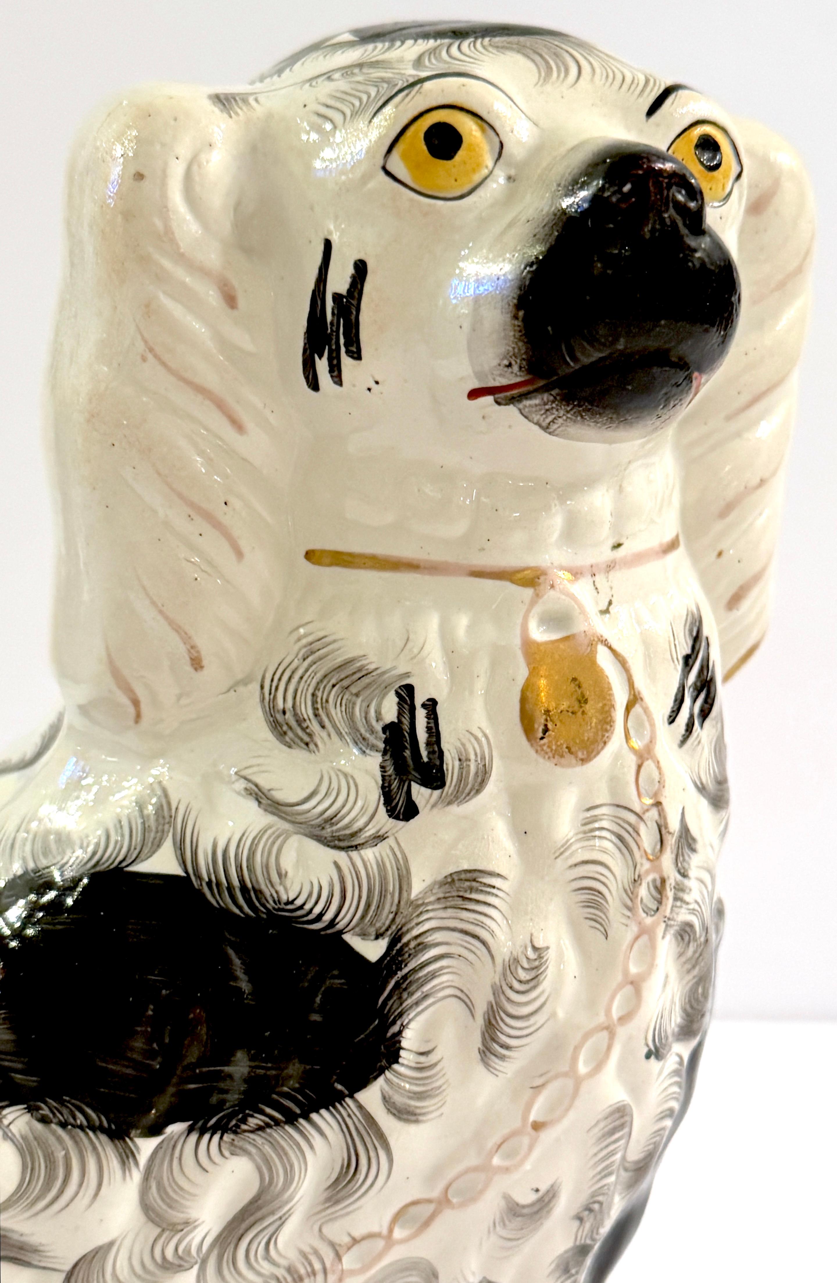 Hand-Painted 19th Century Staffordshire Unique Black & White Spaniel with Separated Foot For Sale