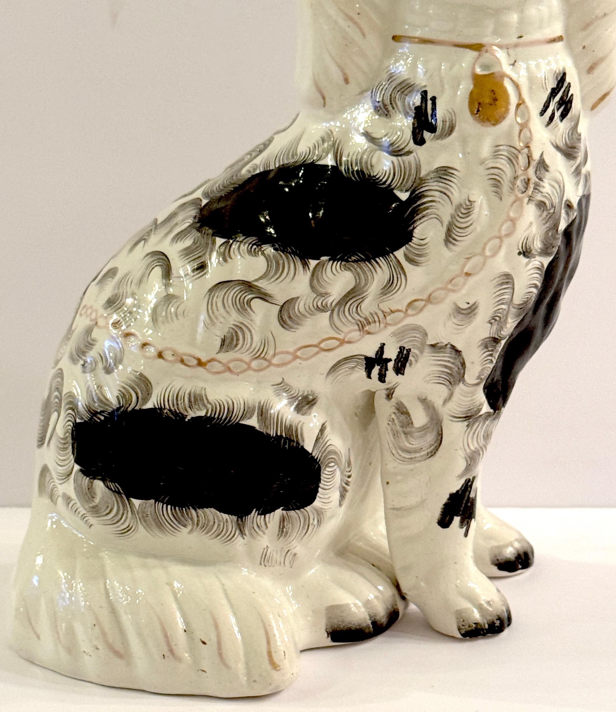 19th Century Staffordshire Unique Black & White Spaniel with Separated Foot In Good Condition For Sale In West Palm Beach, FL
