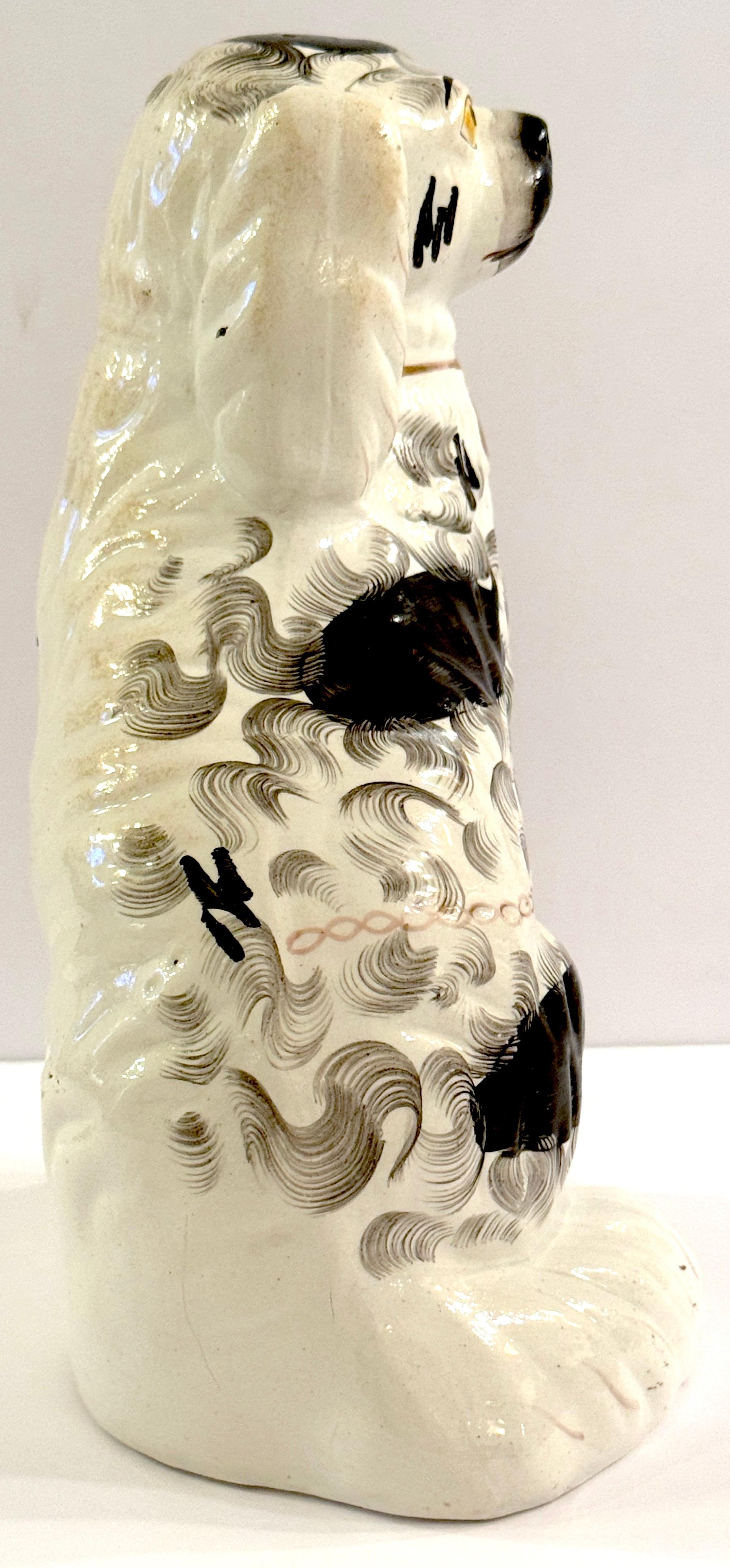 Porcelain 19th Century Staffordshire Unique Black & White Spaniel with Separated Foot For Sale