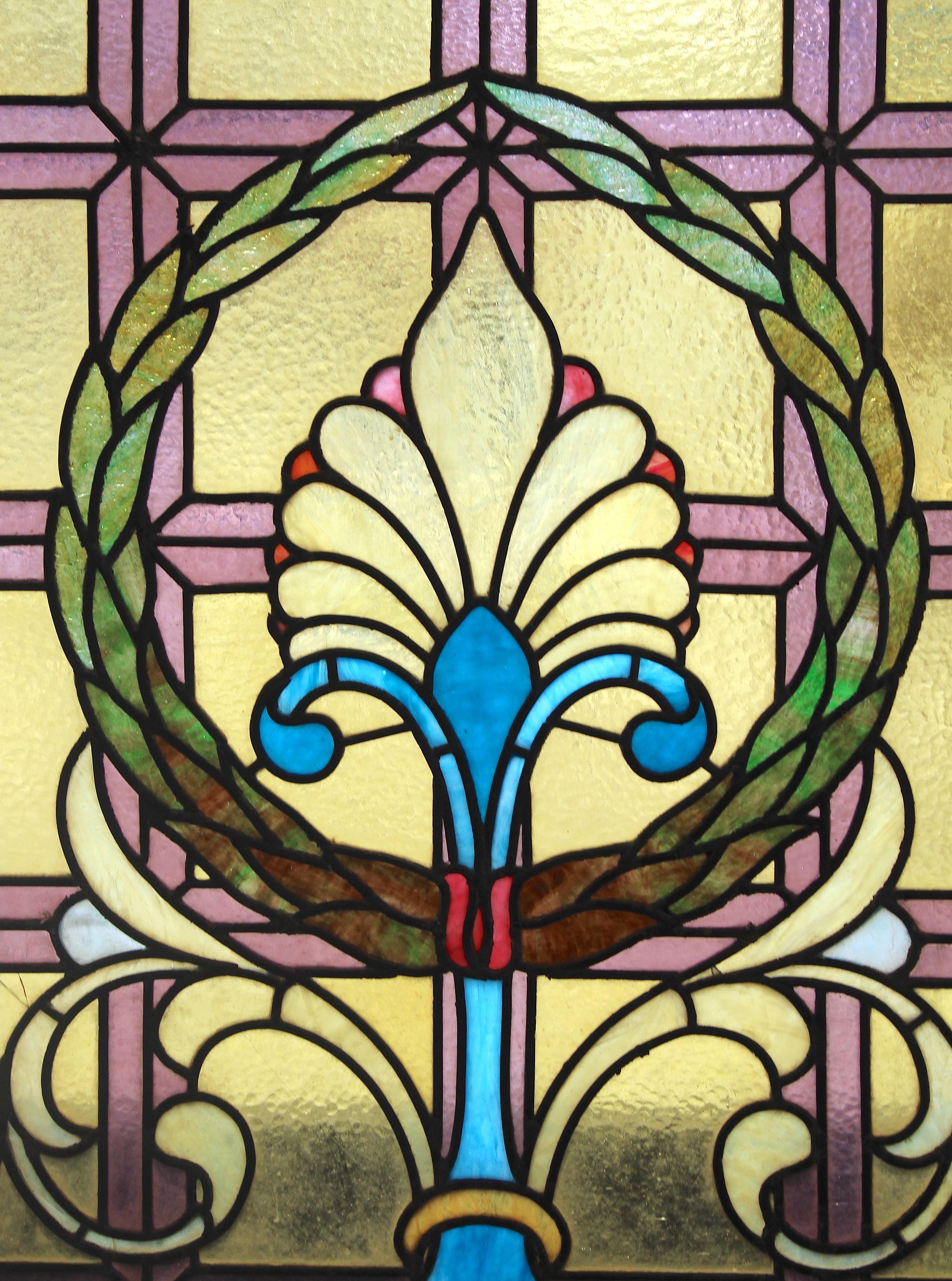 This antique window comes from a home in the Yale New Haven CT area. The window features bright coloring and intricate leaded designs. Geometric squares, scrolling, fleur-de-lis bouquet, and green wreath.
Currently housed in a wooden frame - the
