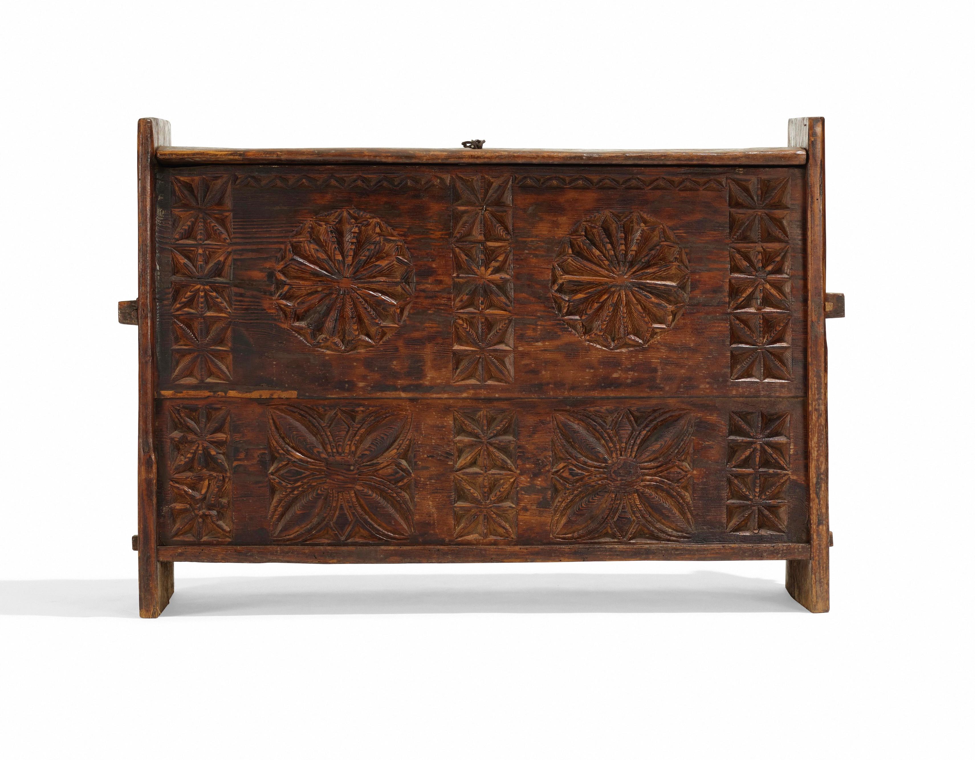 A striking antique chest from the Nuristan province of northeast Afghanistan, dating to the late 19th-early 20th century. Split wood with wedged mortise and tenon construction, a wood-hinged lid fitted with hand forged iron hardware, and its front