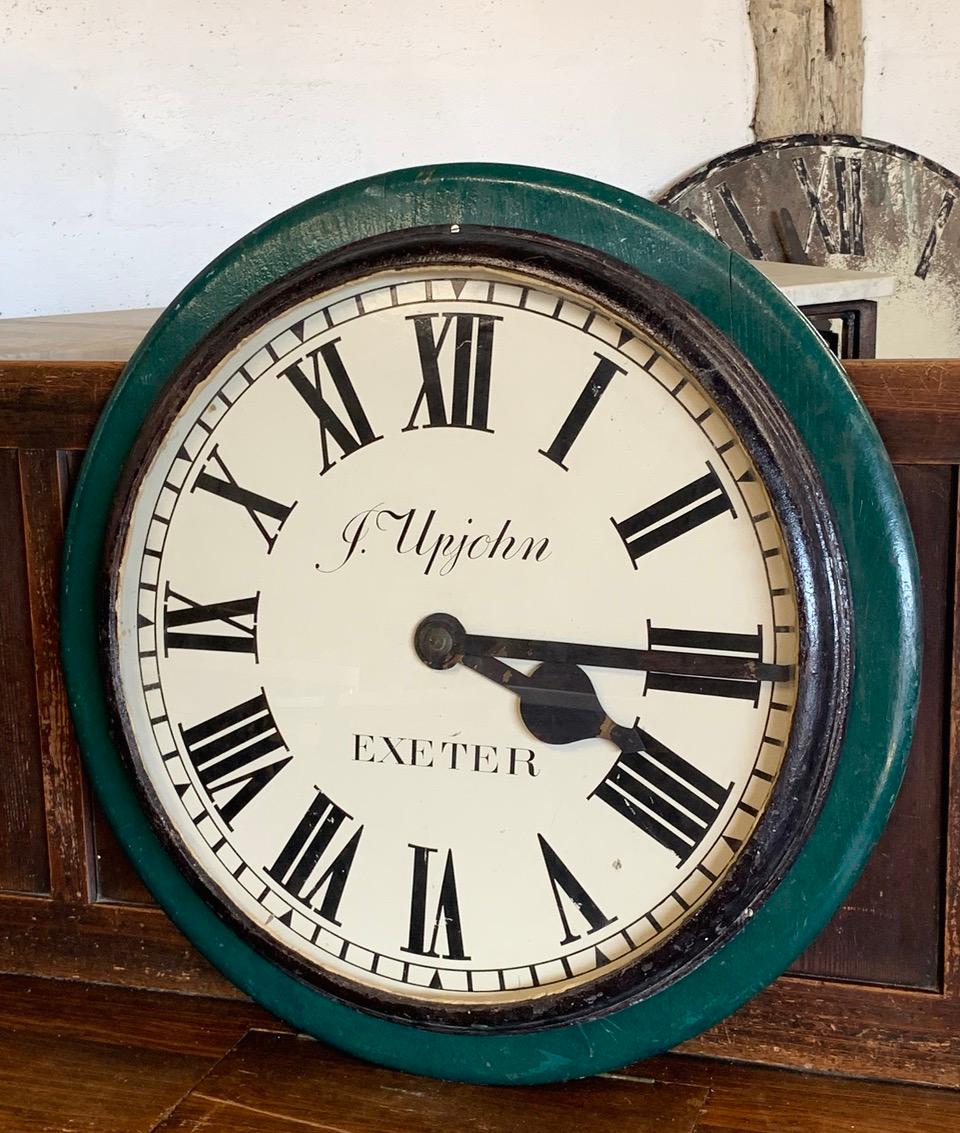 A lovely 19th century station clock by J Upjohn who was part of the famous clock making Upjohn family. The case is made from iron and wood with a painted metal face and hands. This clock would have been part of a larger clock system in the station