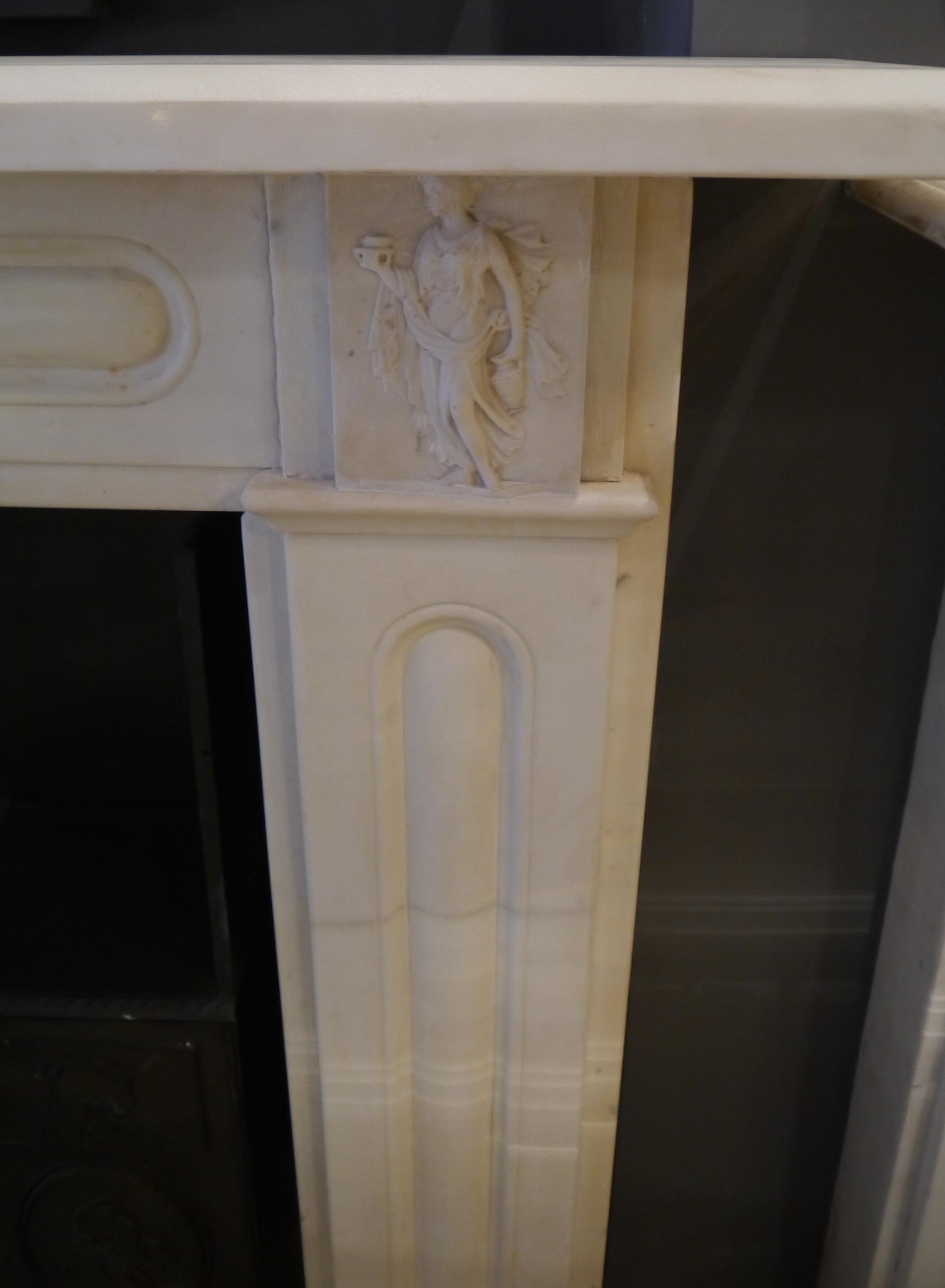 19th century statuary white Regency marble fireplace with carved corner blocks with Huntress Diana and fluted legs and frieze. Opening size 42