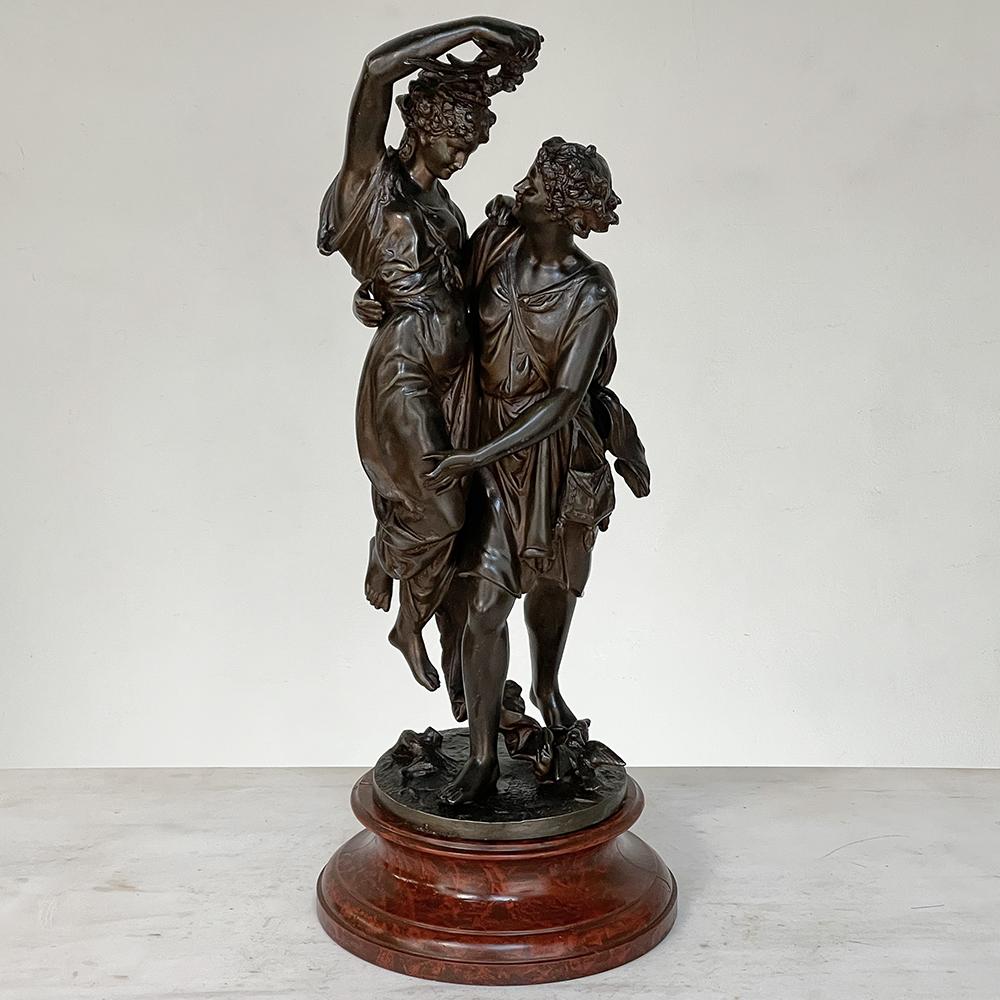 19th century statue of lovers in spelter on faux marble depicts two young lovers in classical raiment enjoying their vitality and company. This idyllic notion rose to incredible popularity during the Belle Epoque, culminating in a variety of
