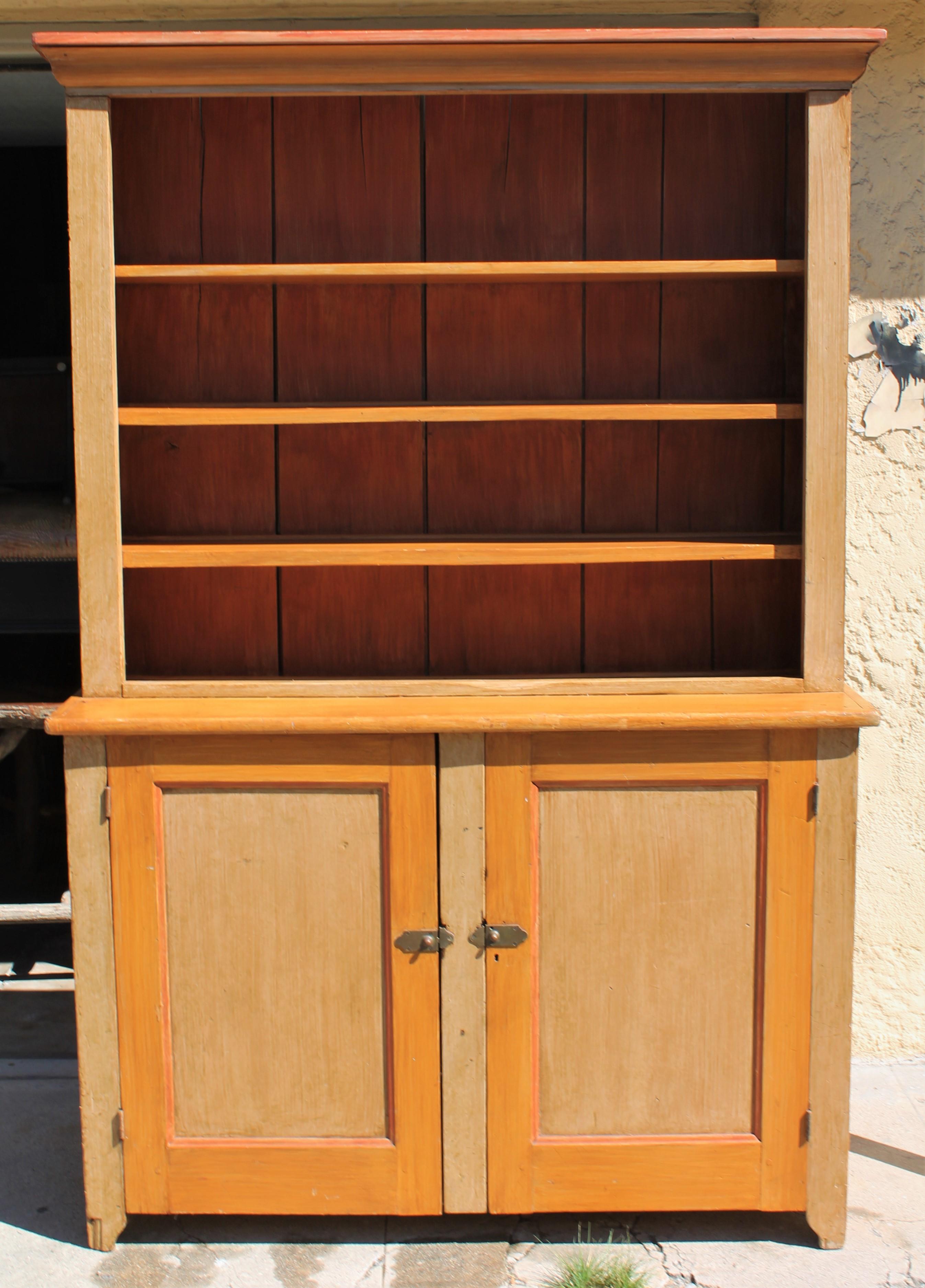 This fine original painted open pewter cupboard is in fine condition with lots of space for your collection of antique dishes or pewter collection. The cream or tan finish with bittersweet trim doors has the original hardware as well. The backboards