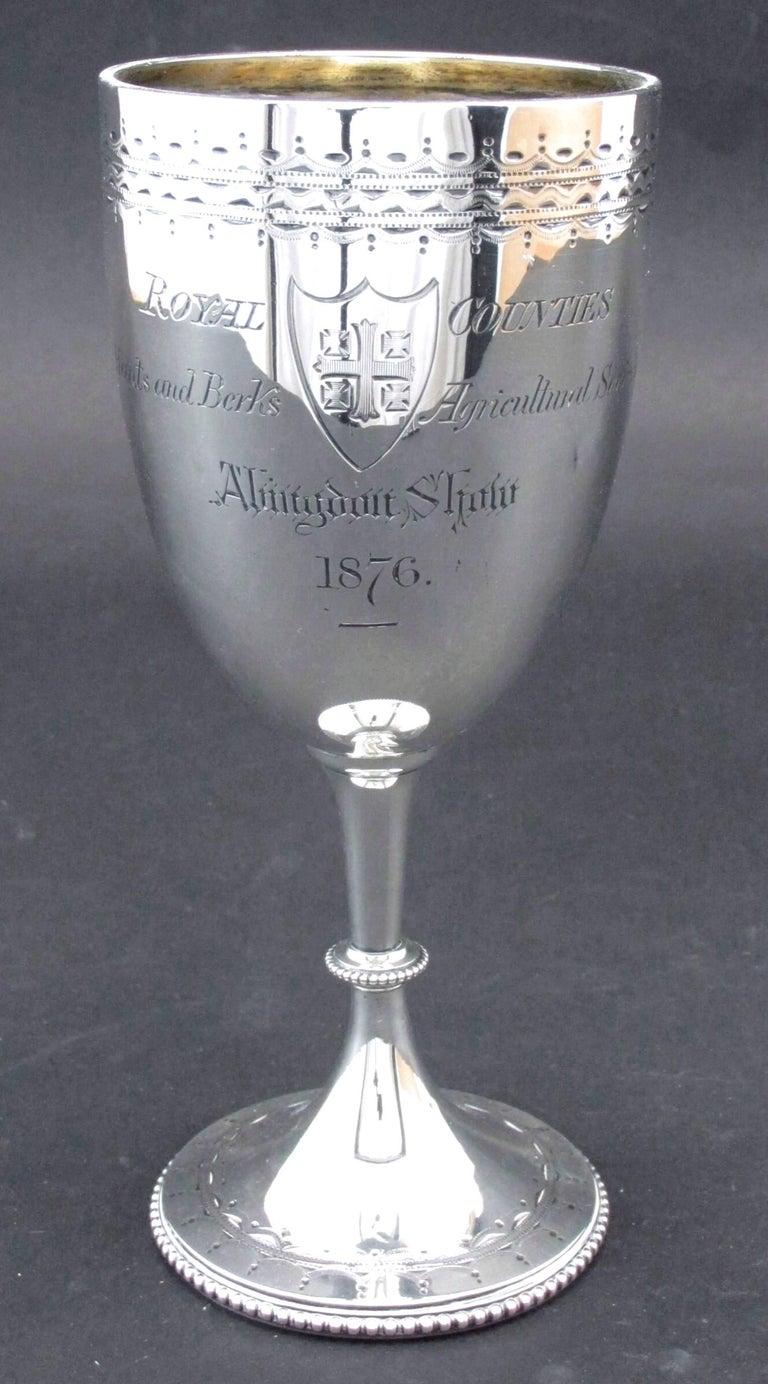 The very ample goblet-shaped body atop a ringed stem rising from spreading circular foot, the interior having a faint gilt wash, the exterior engraved on one side 