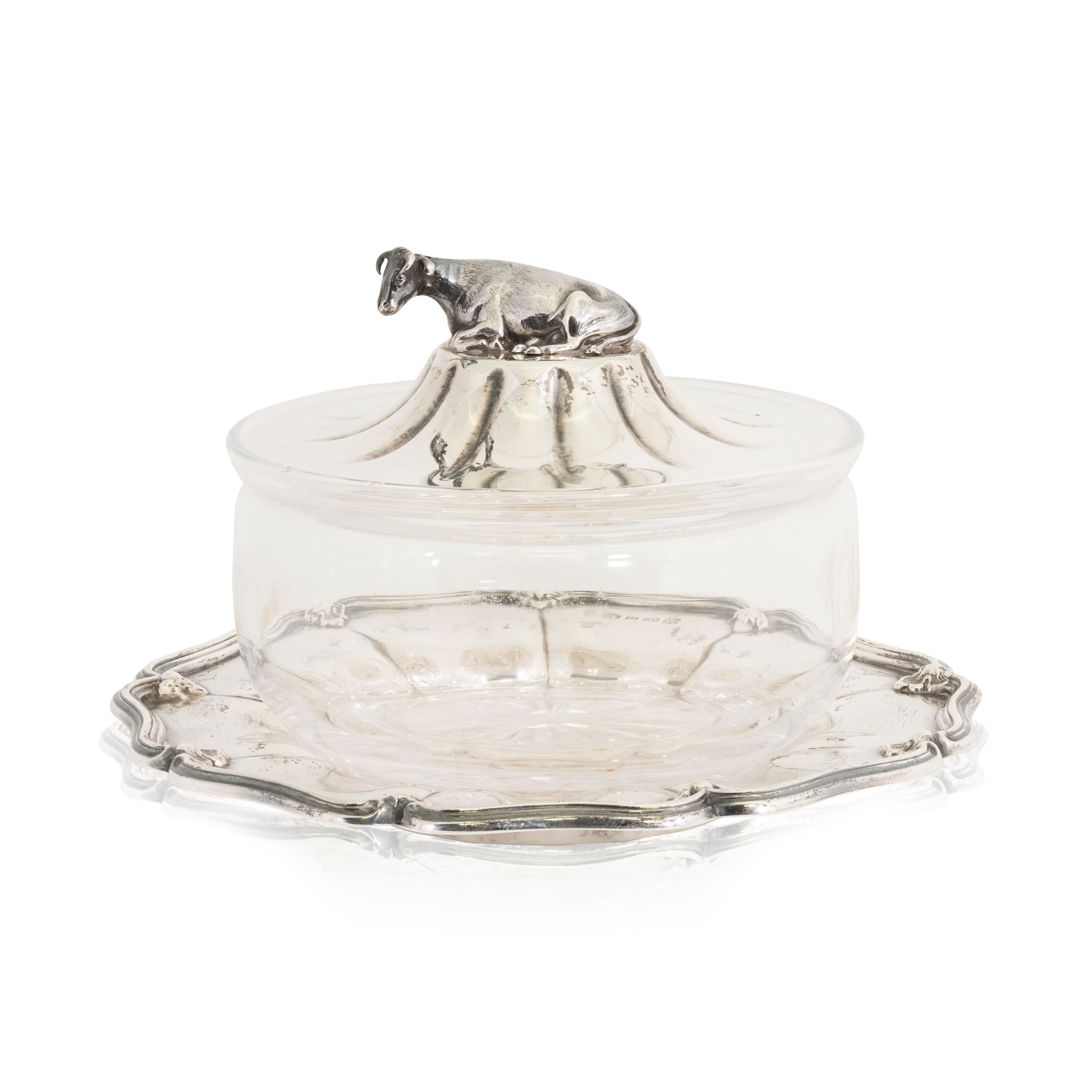 Victorian sterling silver and glass butter dish hallmarked Sheffield 1859 - 1860 by Henry Wilkinson & Co. Glass dish with a serpentine - sterling silver under plate with a molded rim cavetto-dome lid with recumbent cow finial. Sterling elements