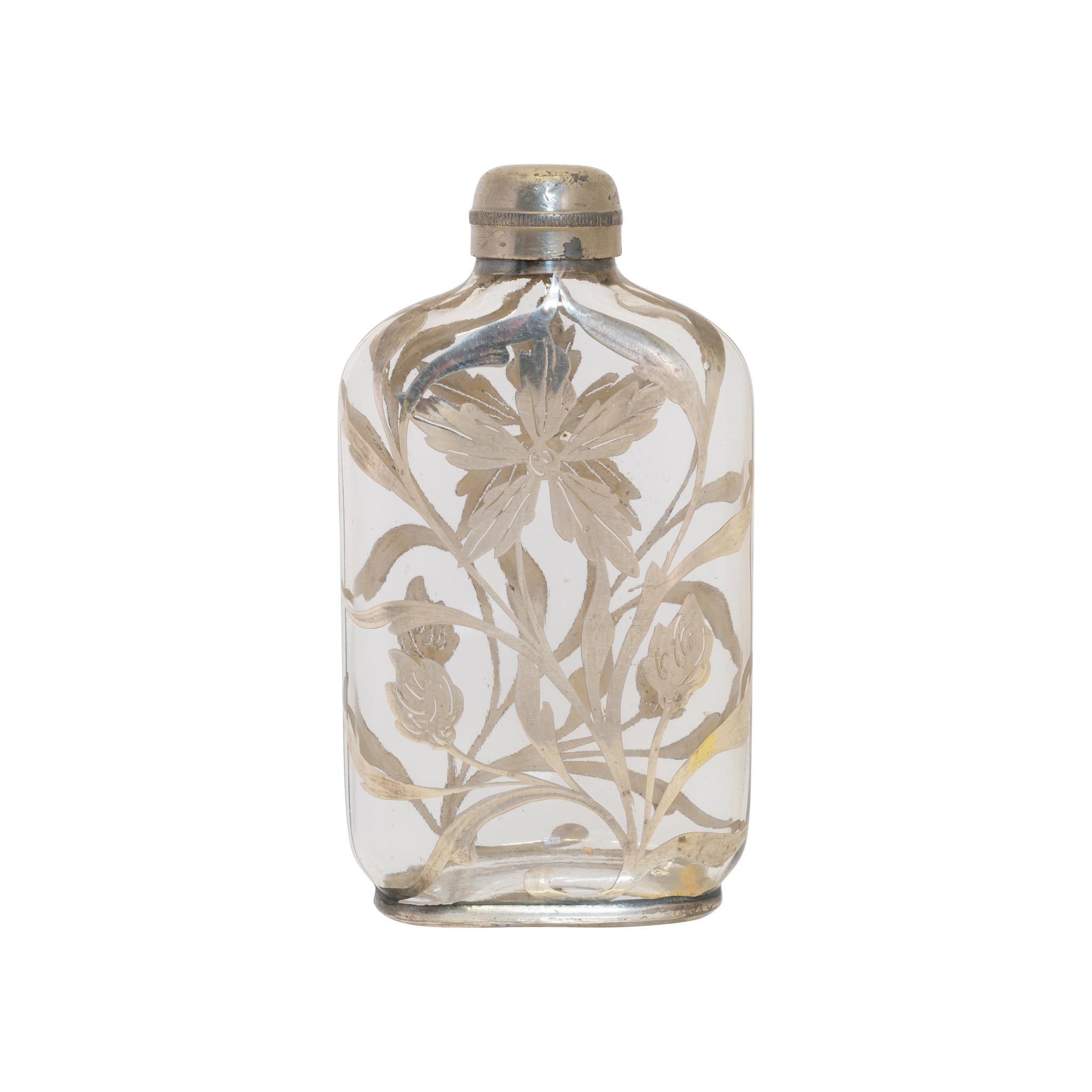 Victorian flask with overlaid sterling flower motif.

PERIOD: Last quarter 19th Century
ORIGIN: United States
SIZE: 4 1/2