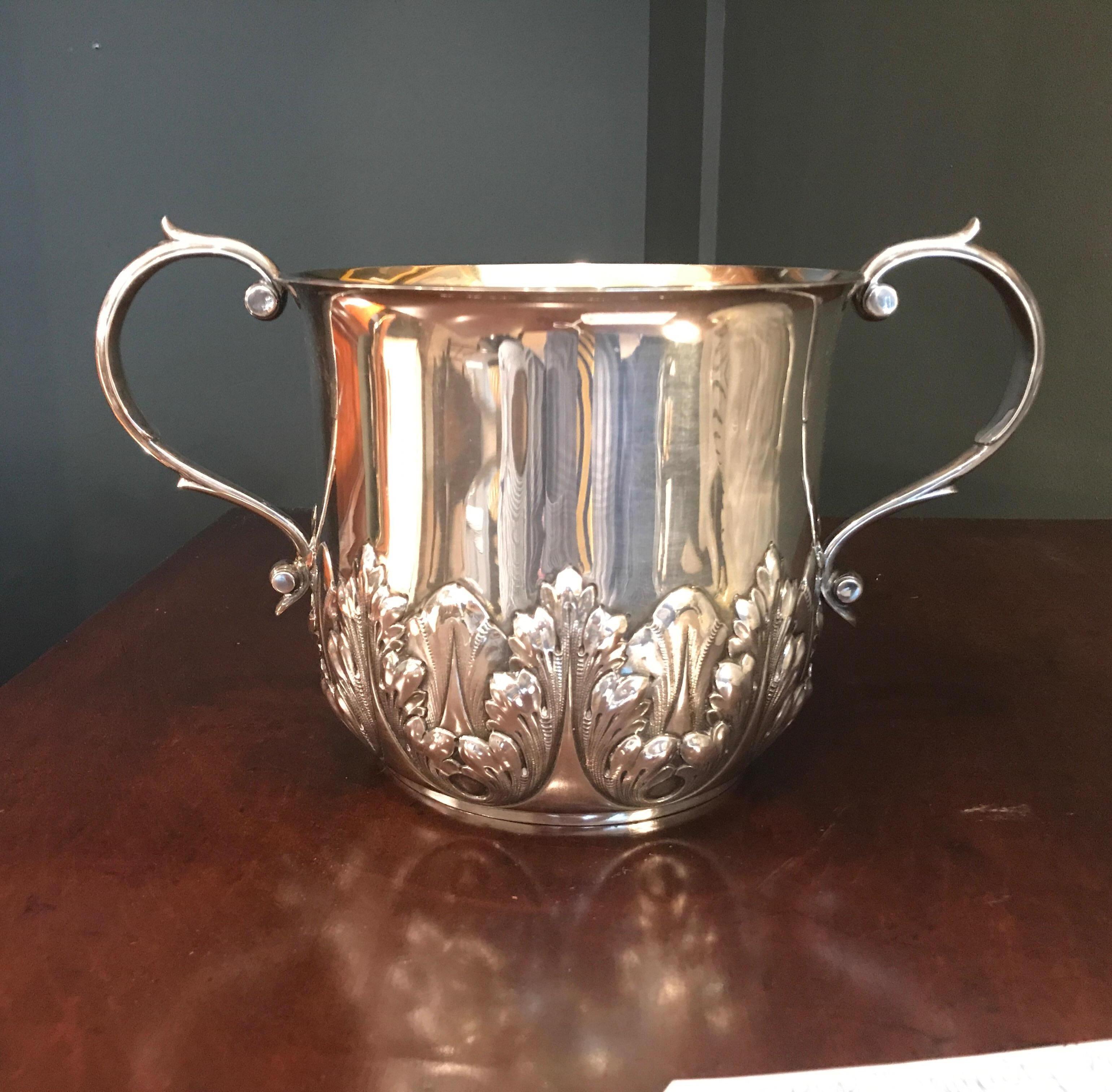 Elegant late 19th century sterling silver loving cup form ice bucket by Dominick and Haff New York. The swan neck handles with smooth upper body with acanthus leaf reposse bottom. A nice sized Ice bucket or a smaller sized whine coole at just under