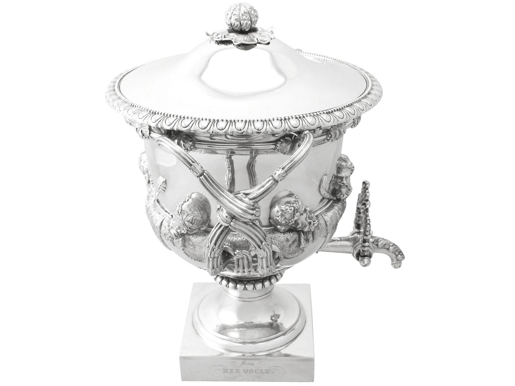 A magnificent, fine and impressive, rare antique George IV English sterling silver Warwick vase/samovar; an addition to our silver presentation collection.

This magnificent antique George IV sterling silver Warwick vase has a Campania shaped form