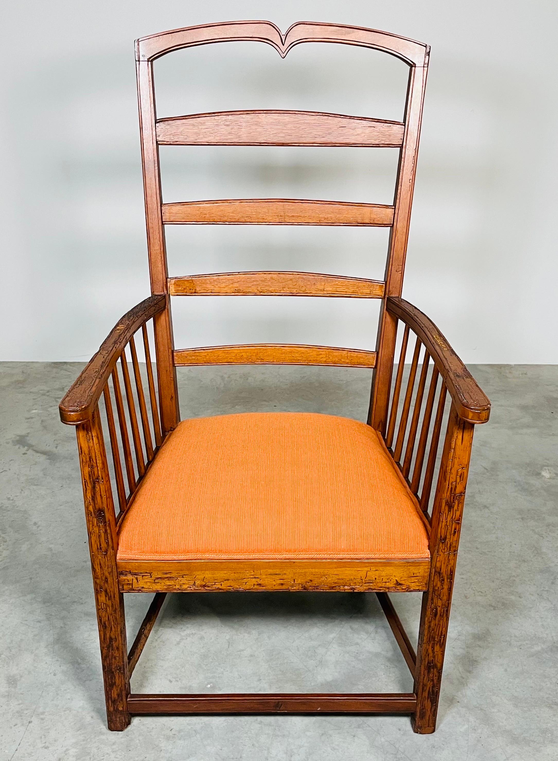 A stunning accent or corner chair having genuine distressed oak wood with ladder back design in the manner of Stickley circa 1860. Authentic distressed beetle wood throughout make this chair a comfortable and eye-grabbing statement piece. The patina