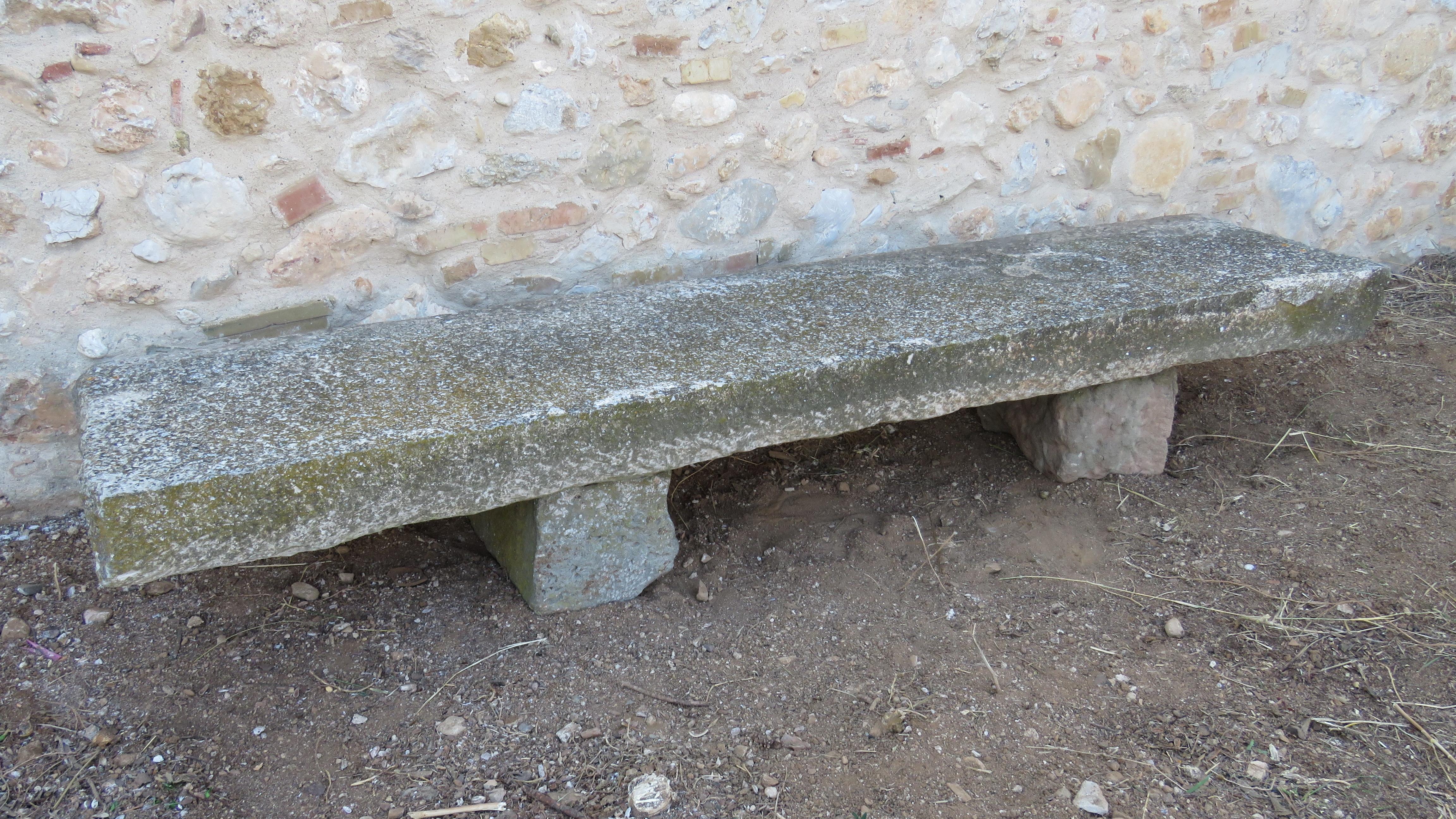 Of massive rectangular roughly hewn form raised on rectangular section plinths.