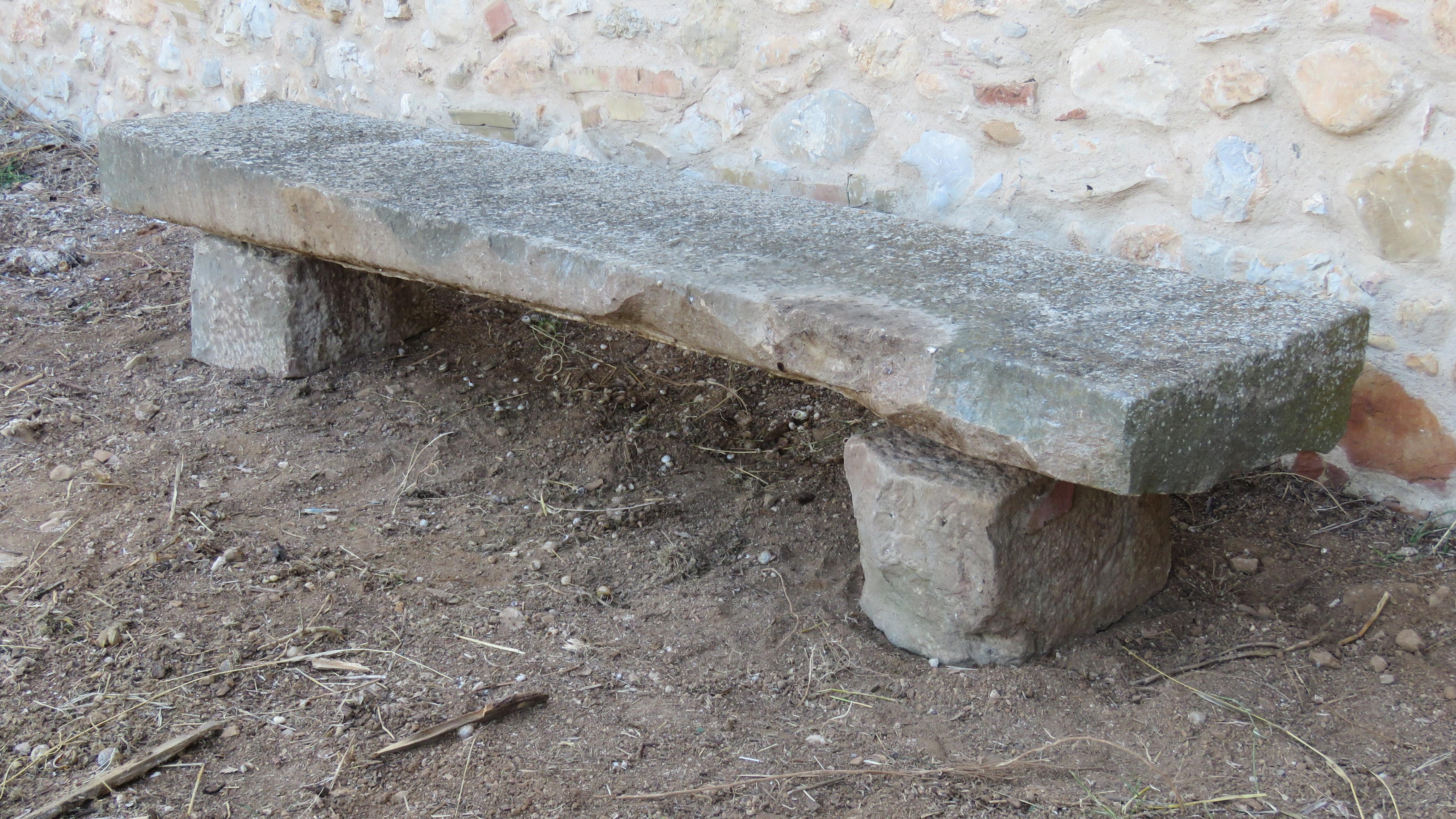 Of massive slightly rectangular roughly hewn form raised on triangular section plinths

The one piece top measures: 22