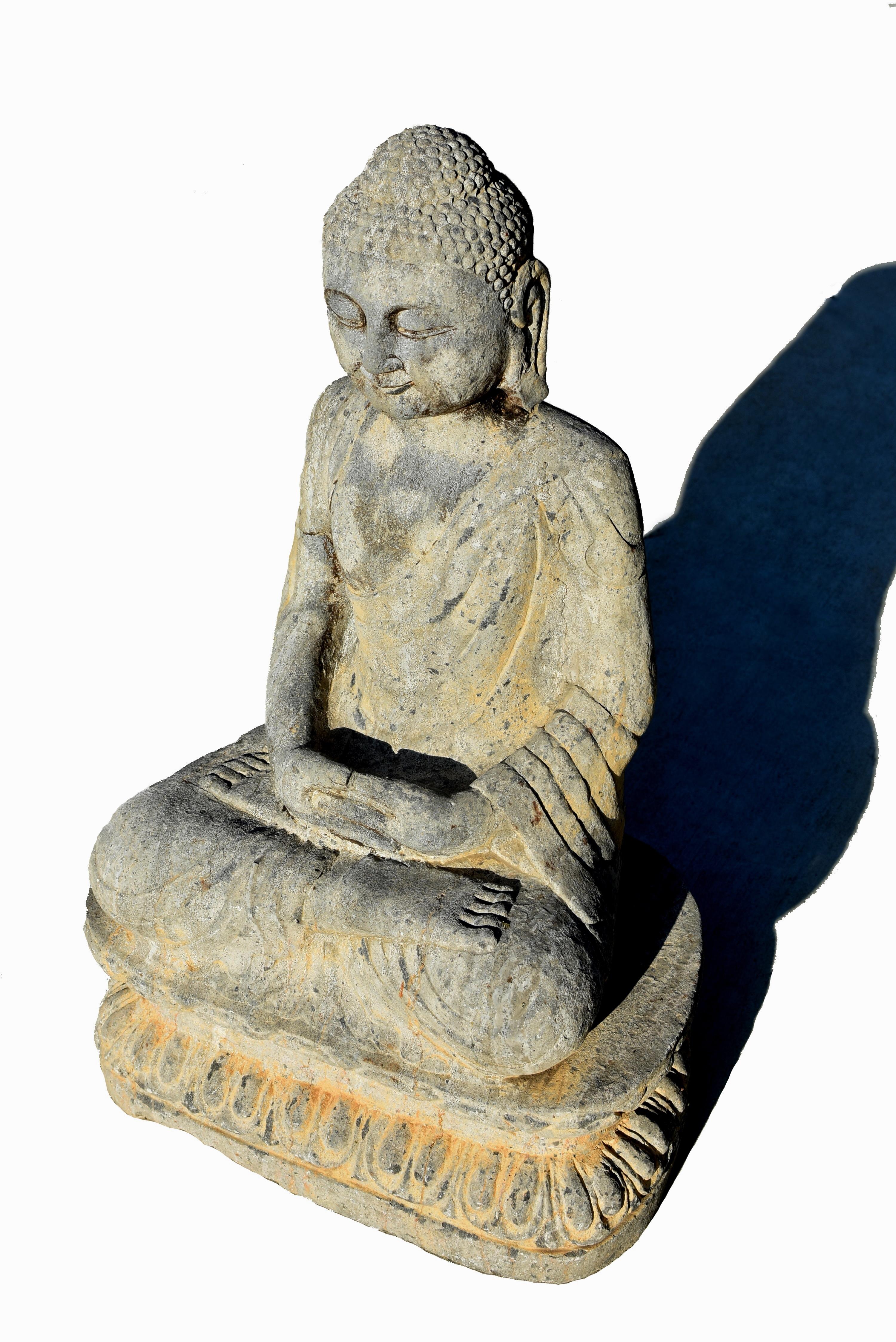 A beautiful antique stone Buddha Shakyamuni. Seated in dhyana asana on a double lotus throne, hands in dhyana mudra, wearing a sanghati pleated end draped over his left shoulder and folded neatly under his legs. Portrayed with a serene face framed