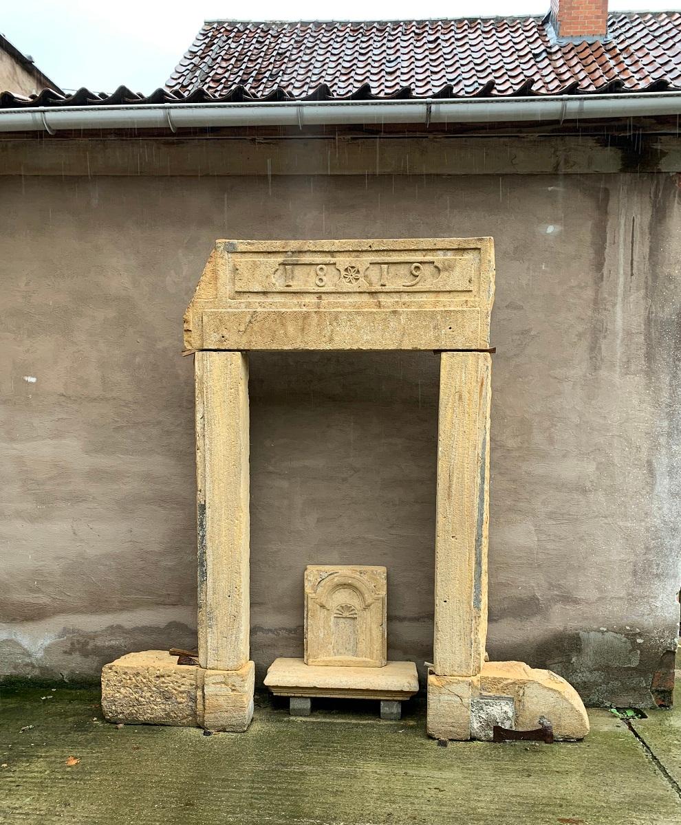 A 19th century stone door surround. Simply but elegant rustic executed. Dated 1819 and decoretad with a geometric frieze and centrel flower rozet. Innner dimensions 180 x 105, outer dimensions 230 x 170. 
Please note that the showed niche is not